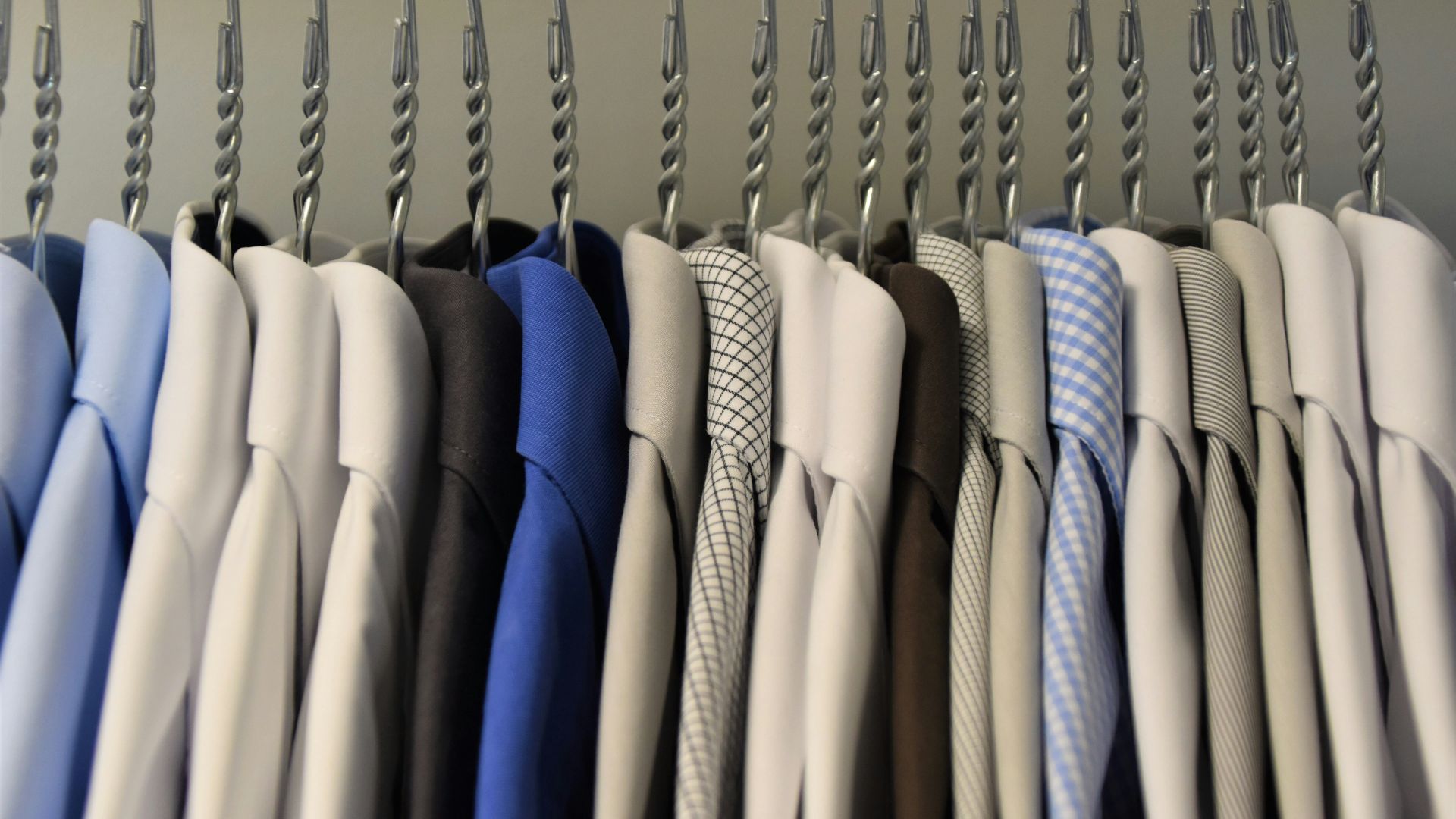 assorted color dress shirt lot on clothes hangers