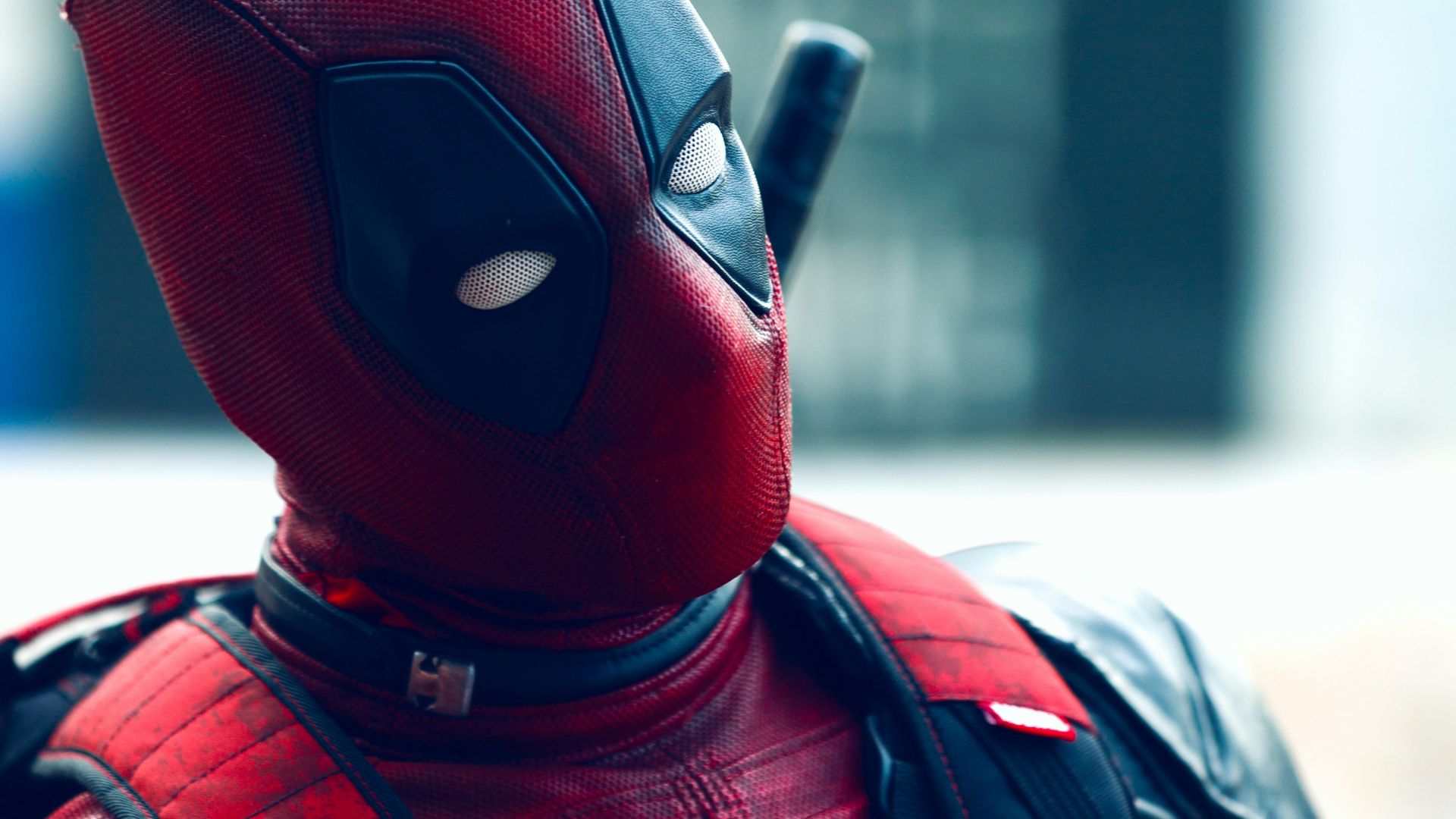 a man in a deadpool costume with a knife in his hand