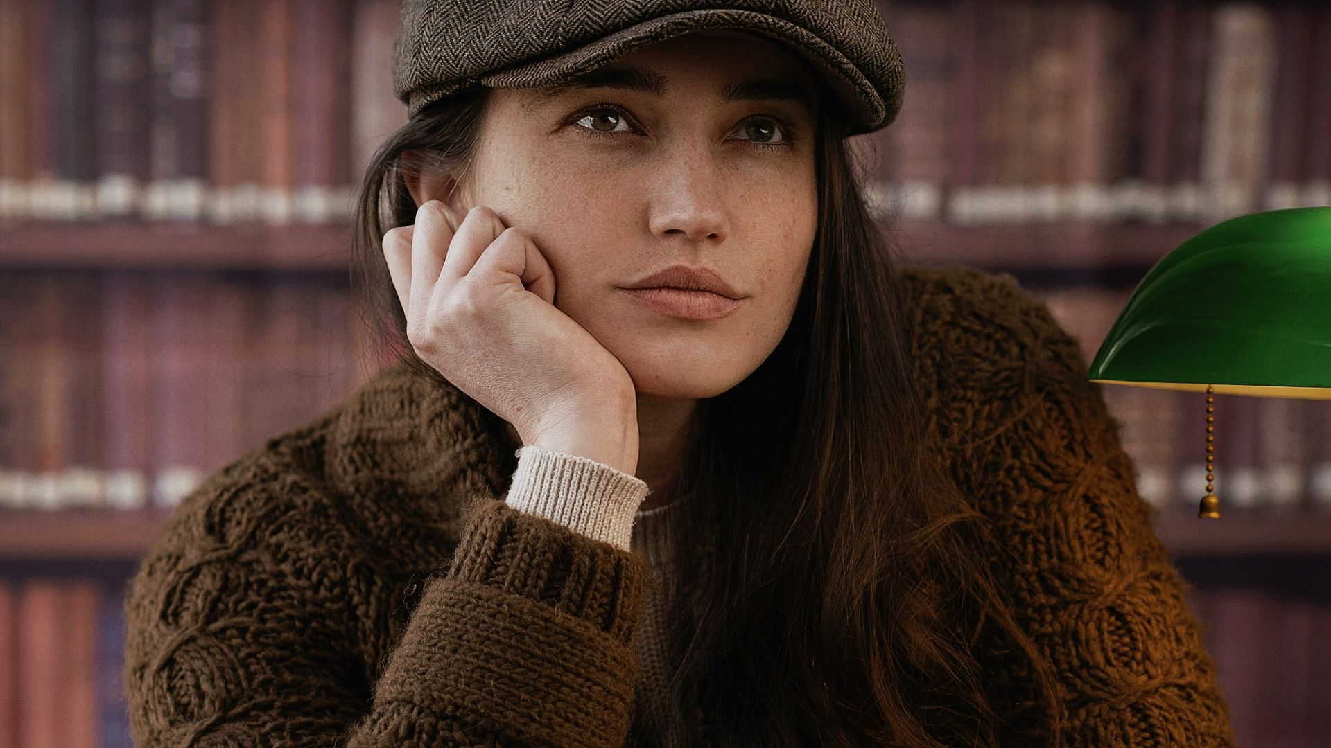 a woman sitting at a table with a chess board