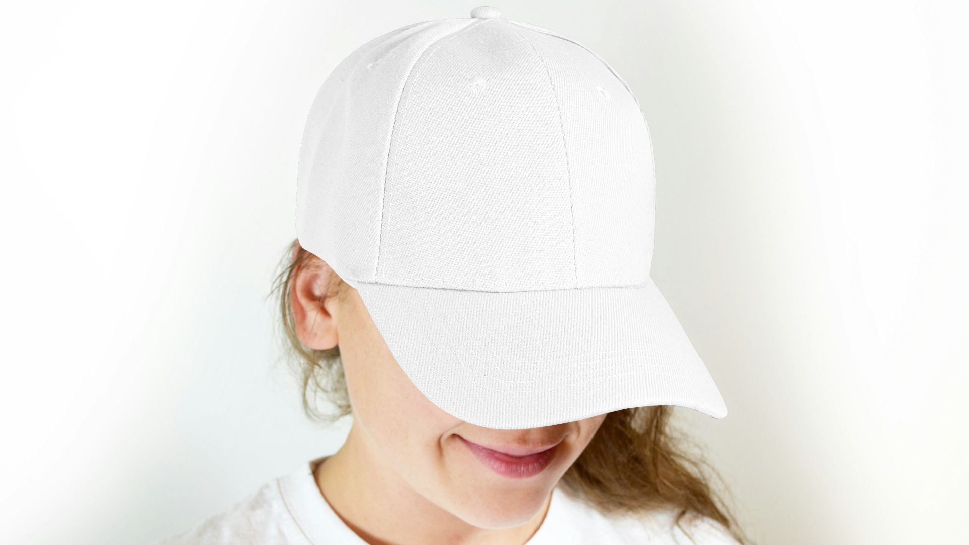 woman in white crew neck shirt wearing white cap