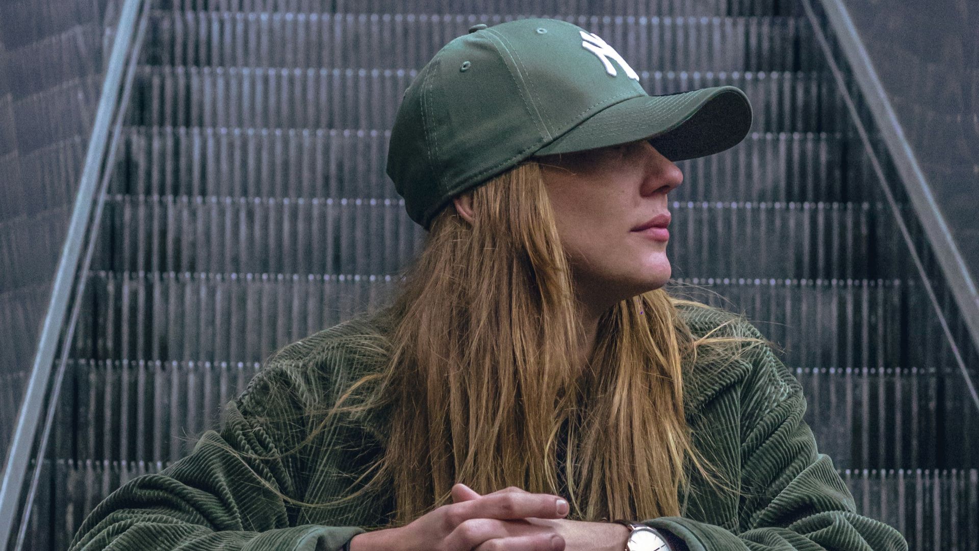 woman sitting on escalator