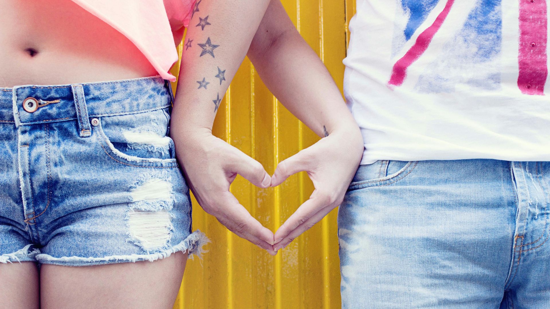 man and woman's hands forming heart