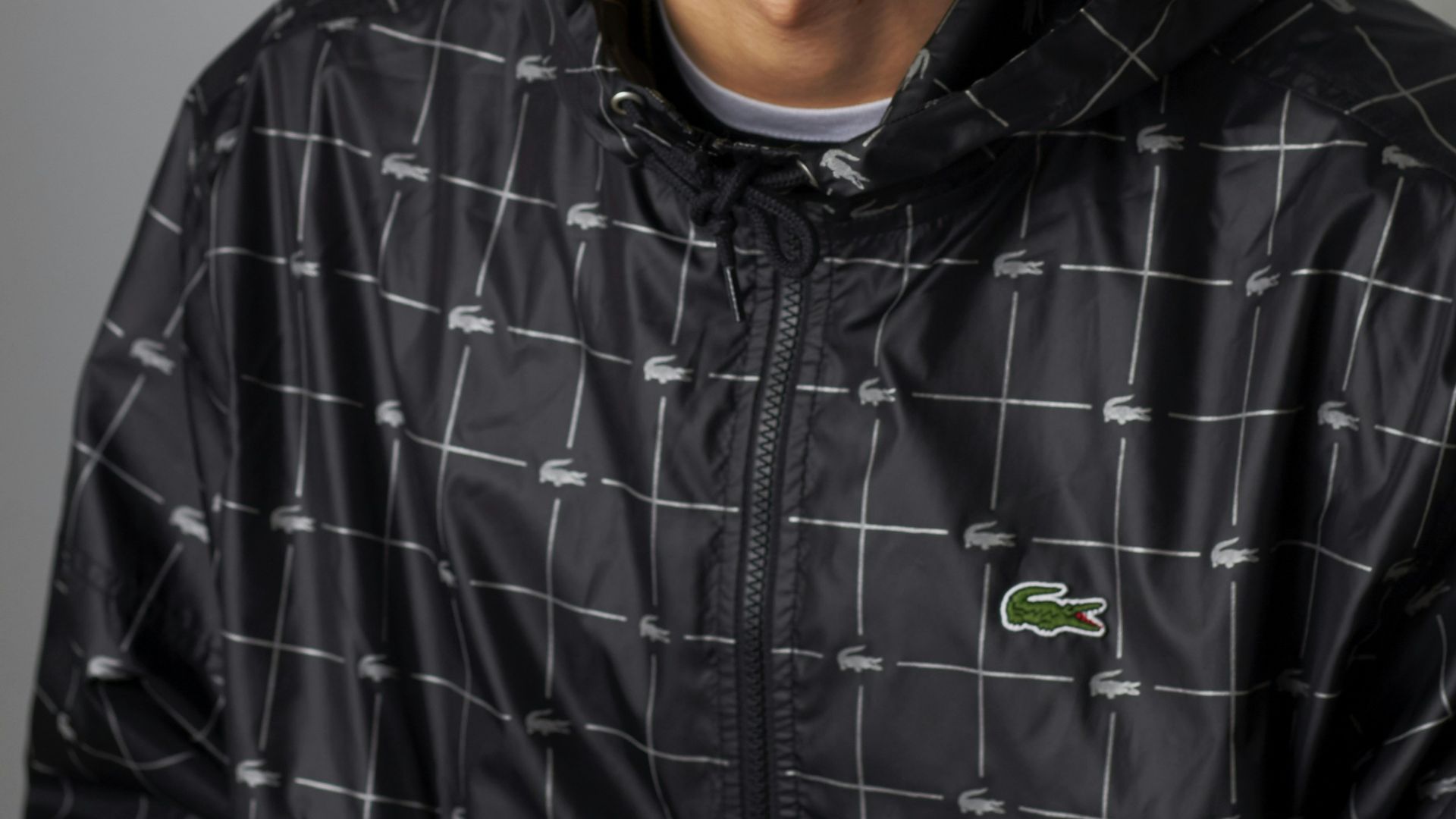 man wearing Lacoste zip-up hooded top