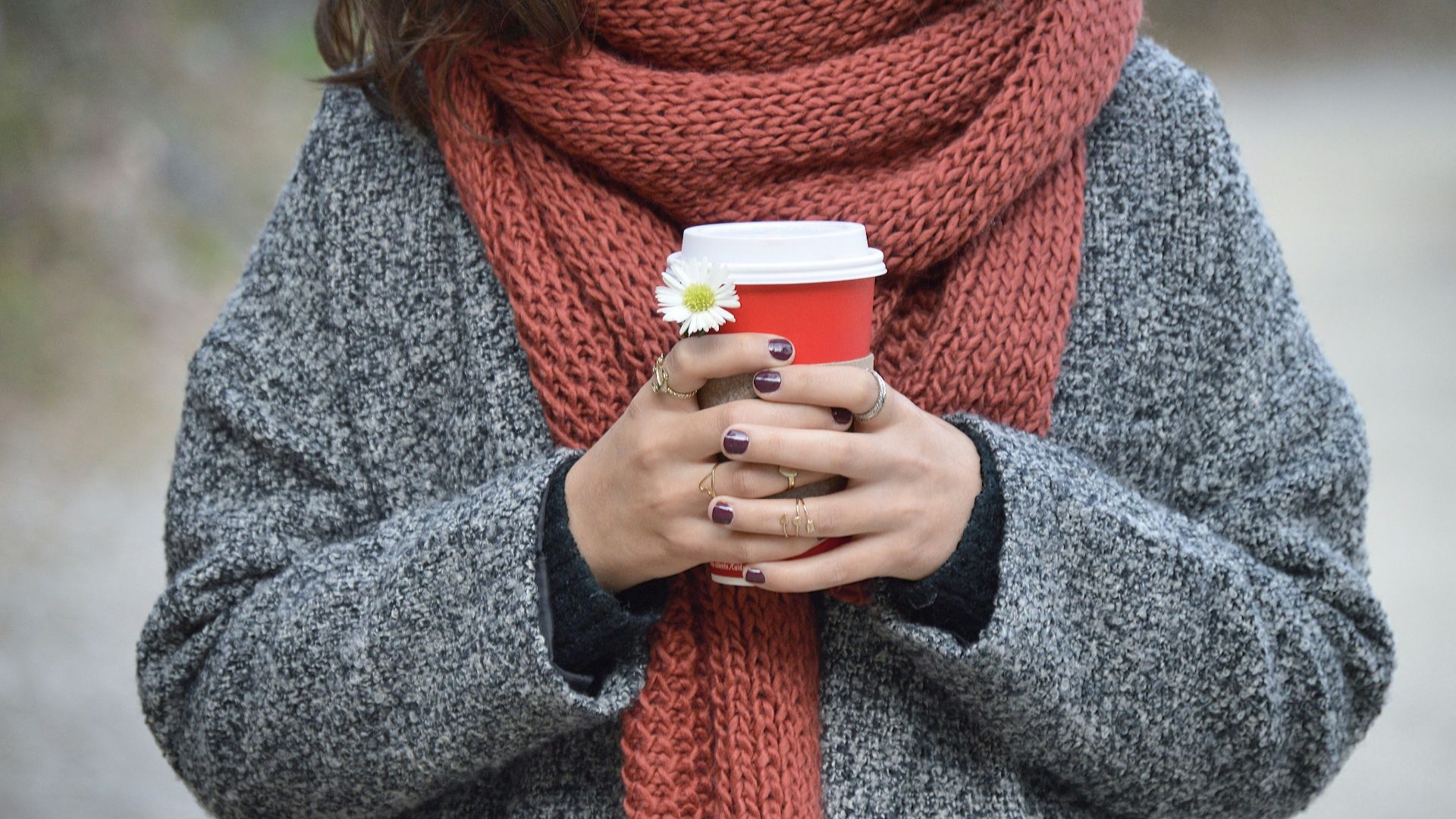 person holding red and white disposable cup