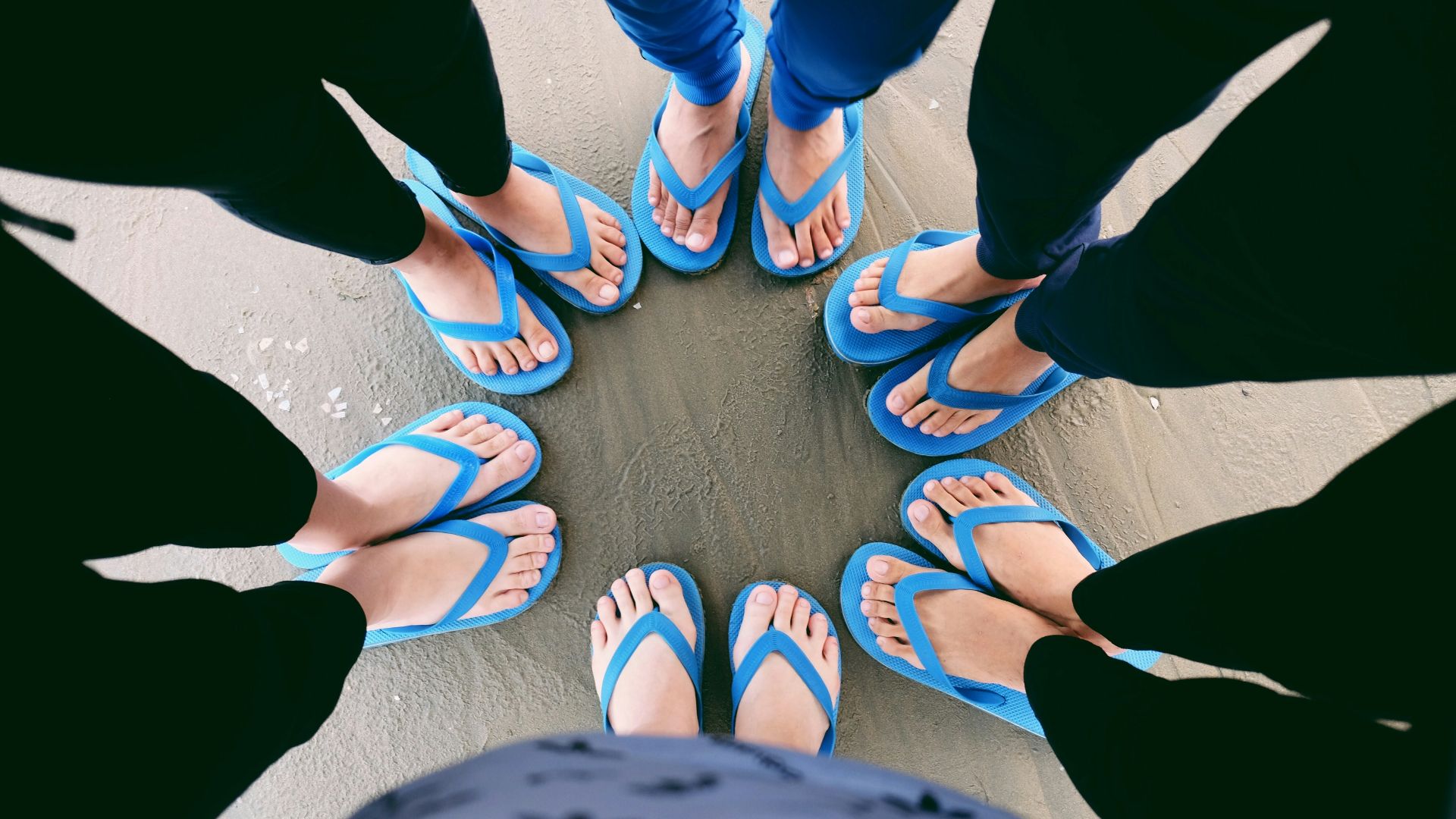 six people wearing blue flip-flops