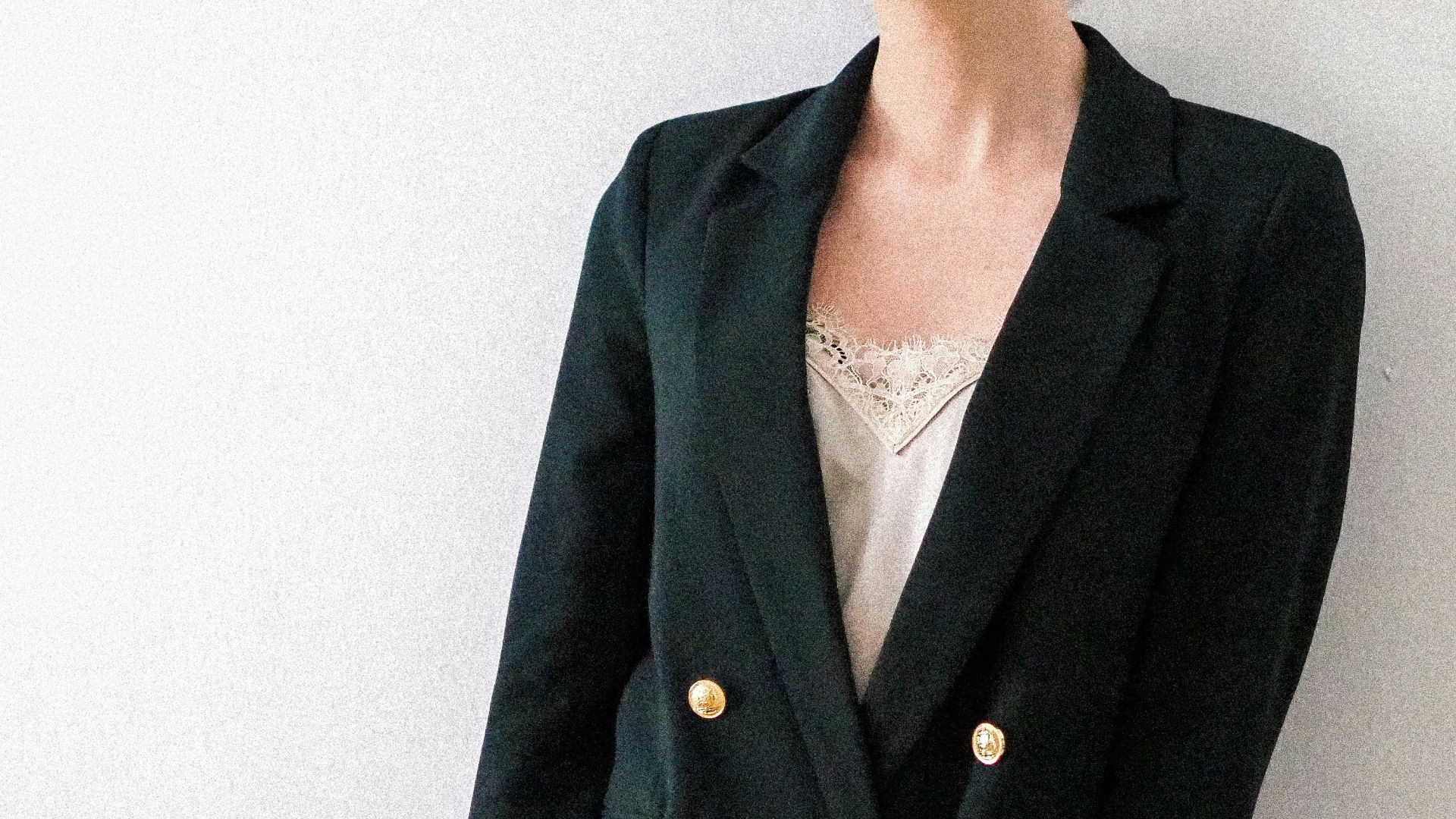 woman in black blazer standing