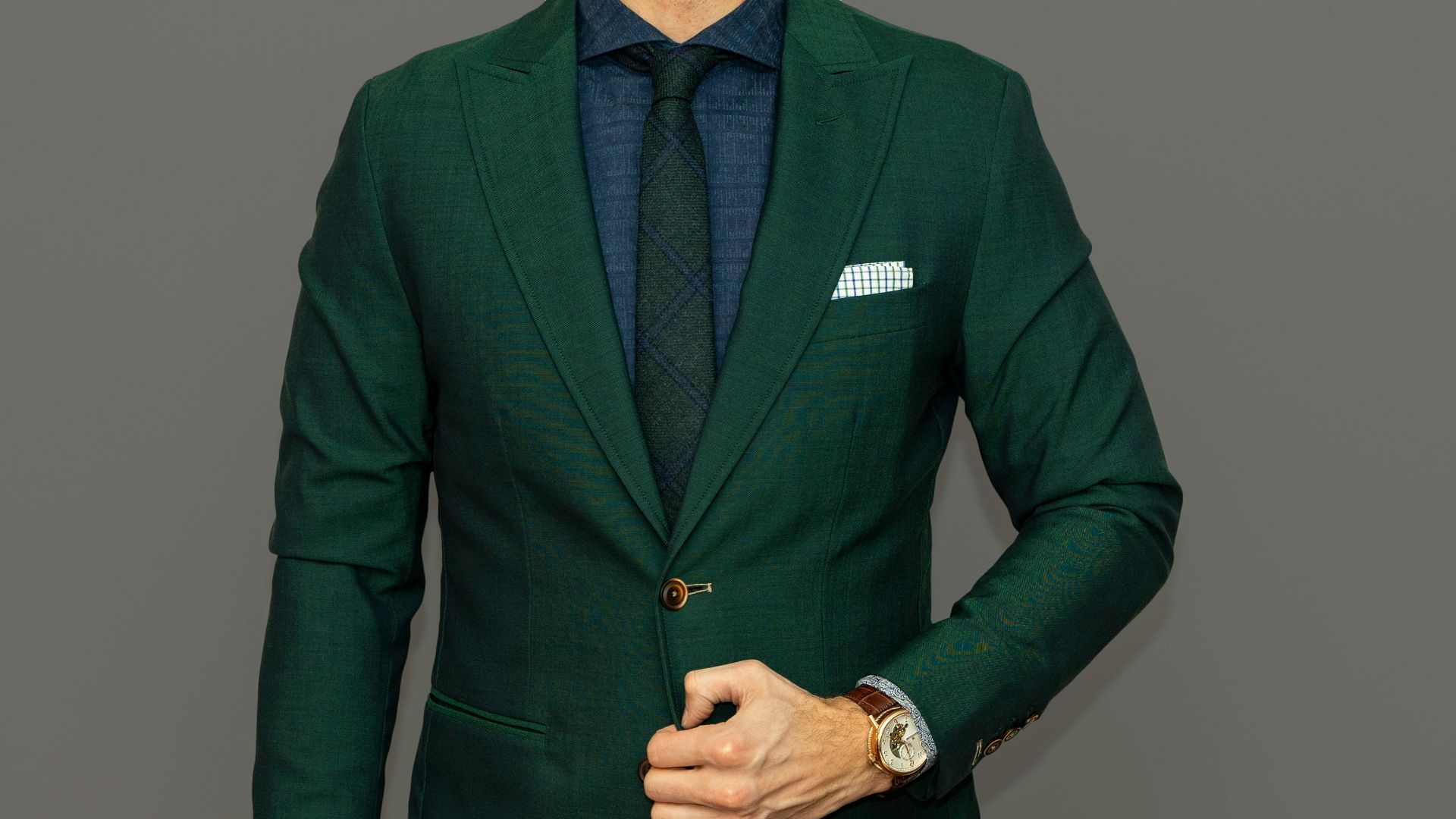 man in blue suit jacket and black pants