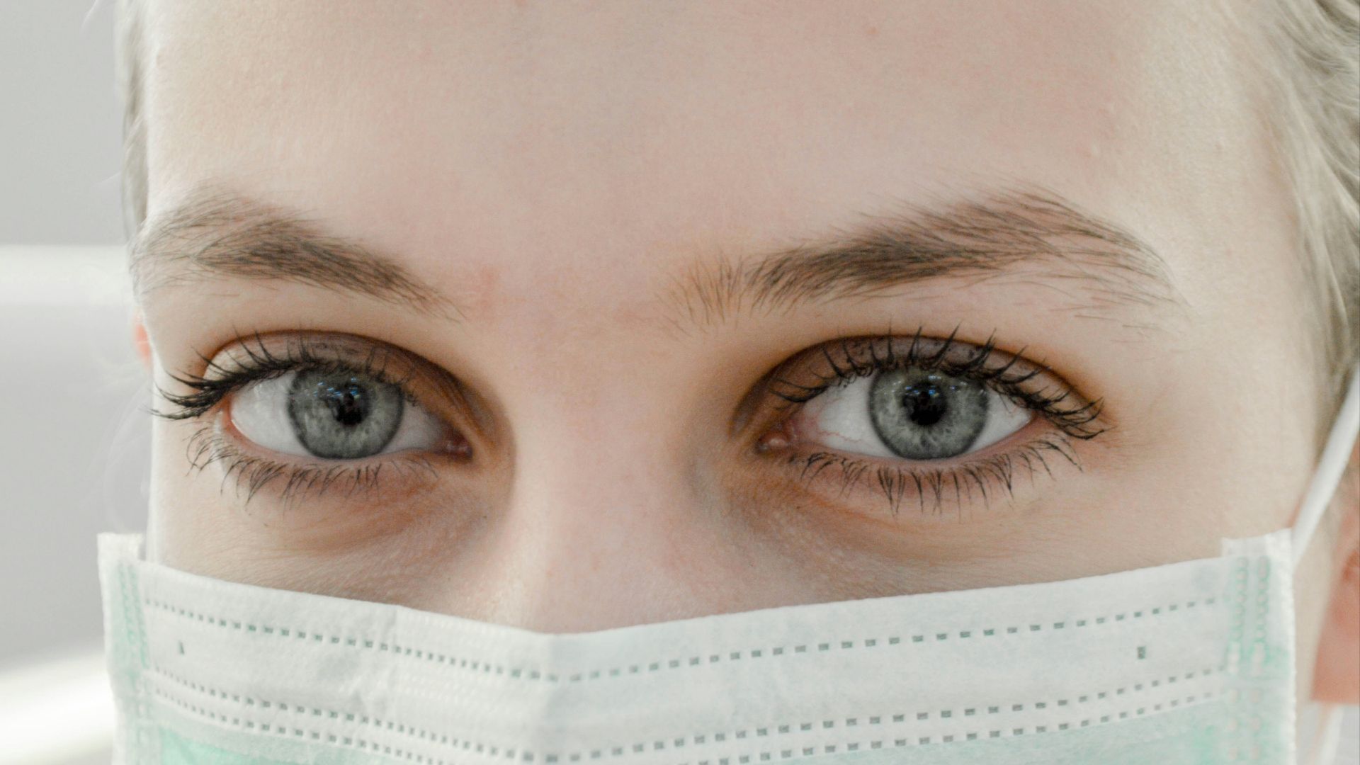 closeup photo of woman's eye wearing mask