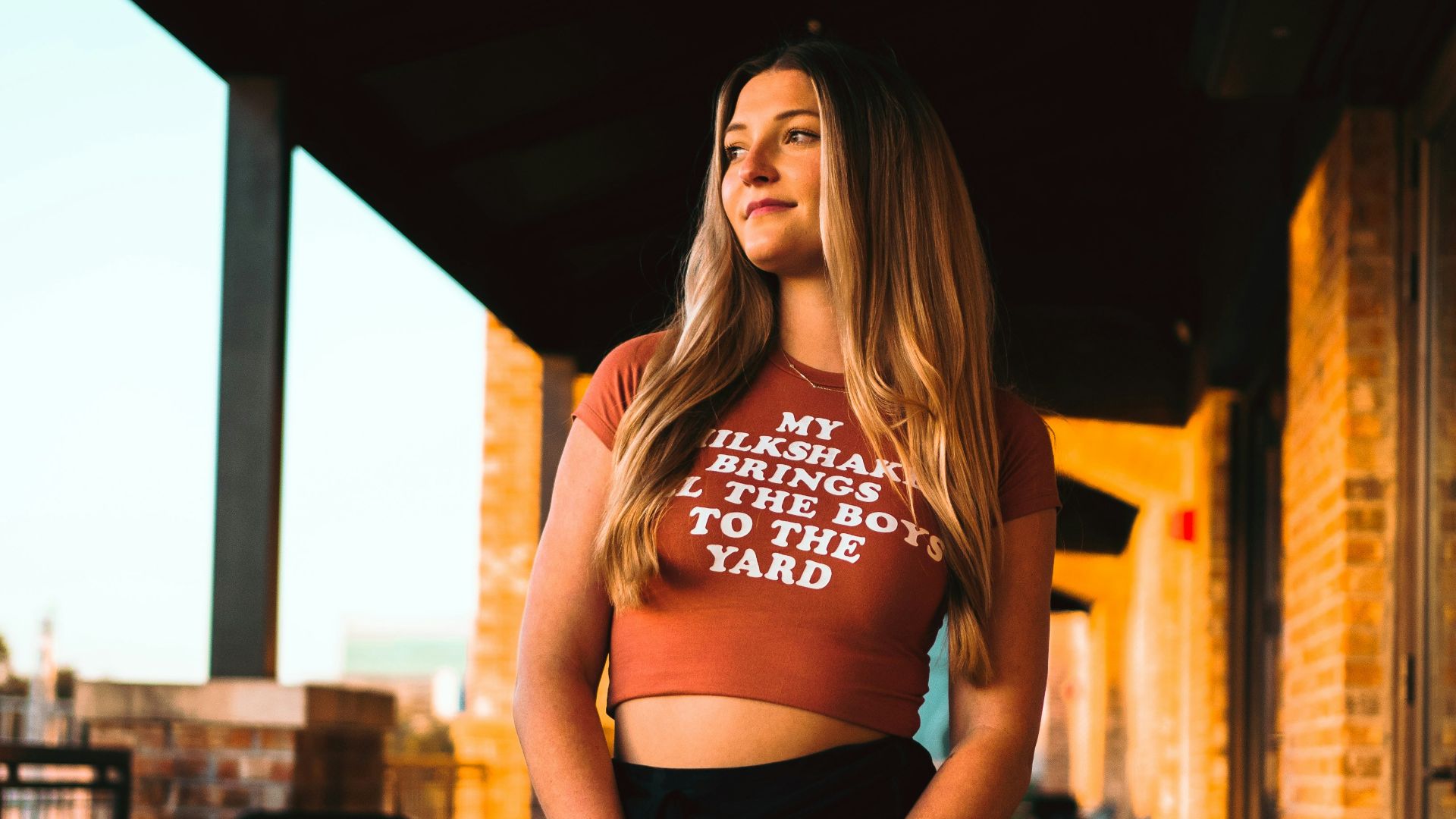 a woman posing for a picture wearing a crop top