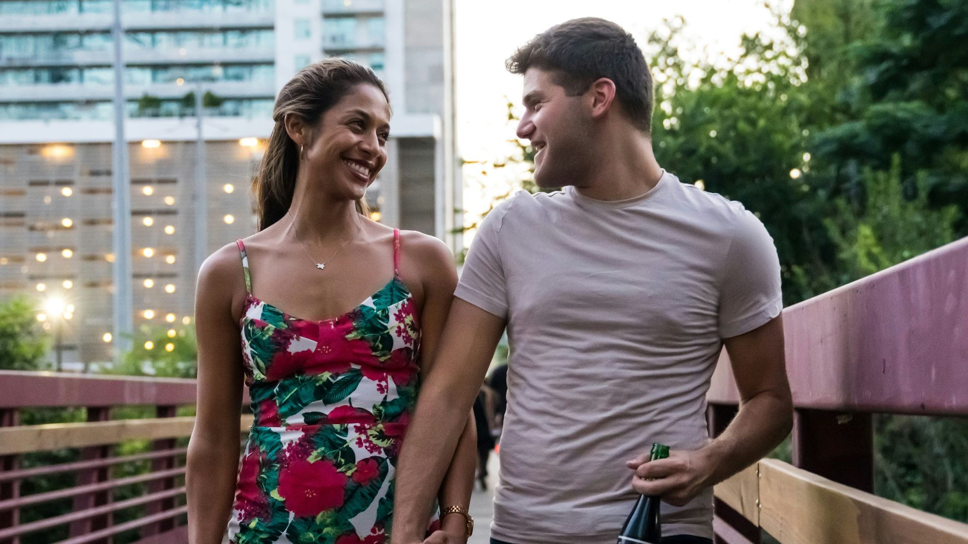 man and woman standing on wooden bridge during daytime