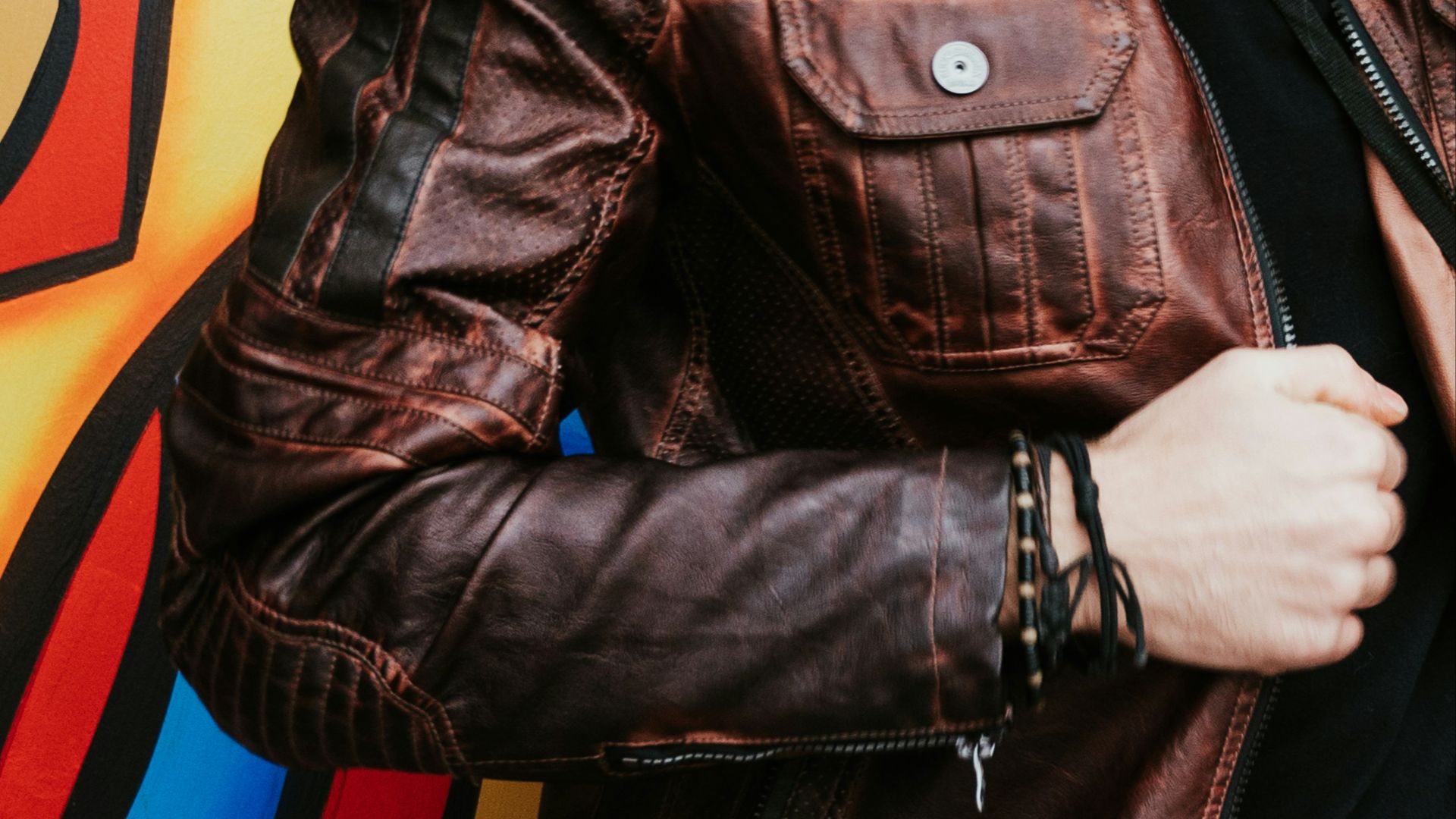 person in brown leather zip-up jacket