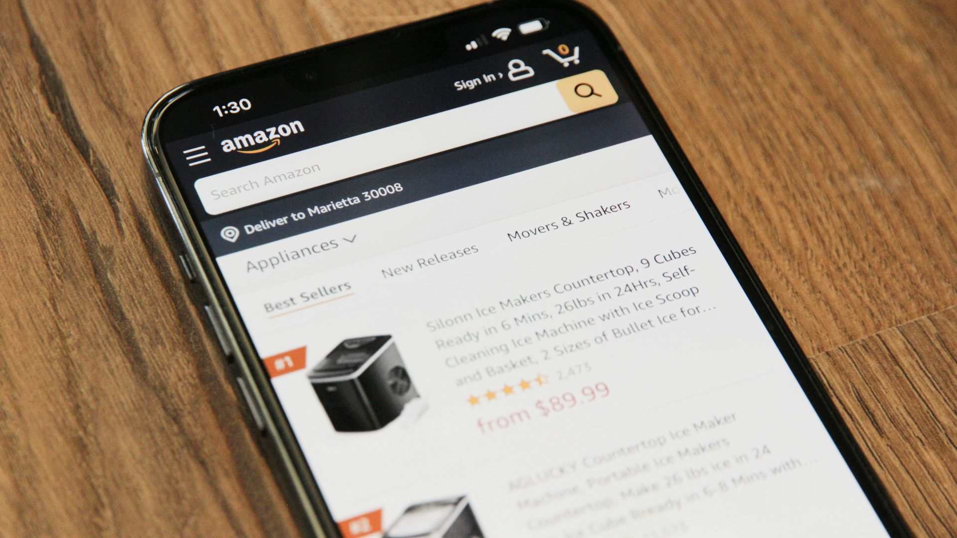 a cell phone sitting on top of a wooden table