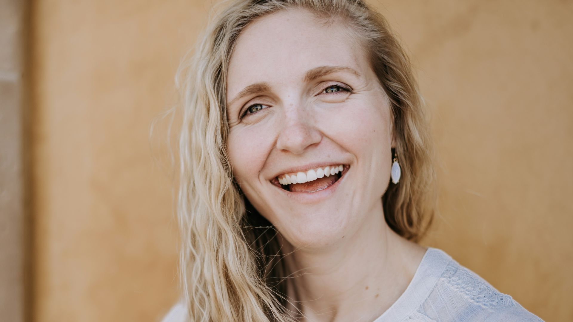 smiling woman in white lace shirt