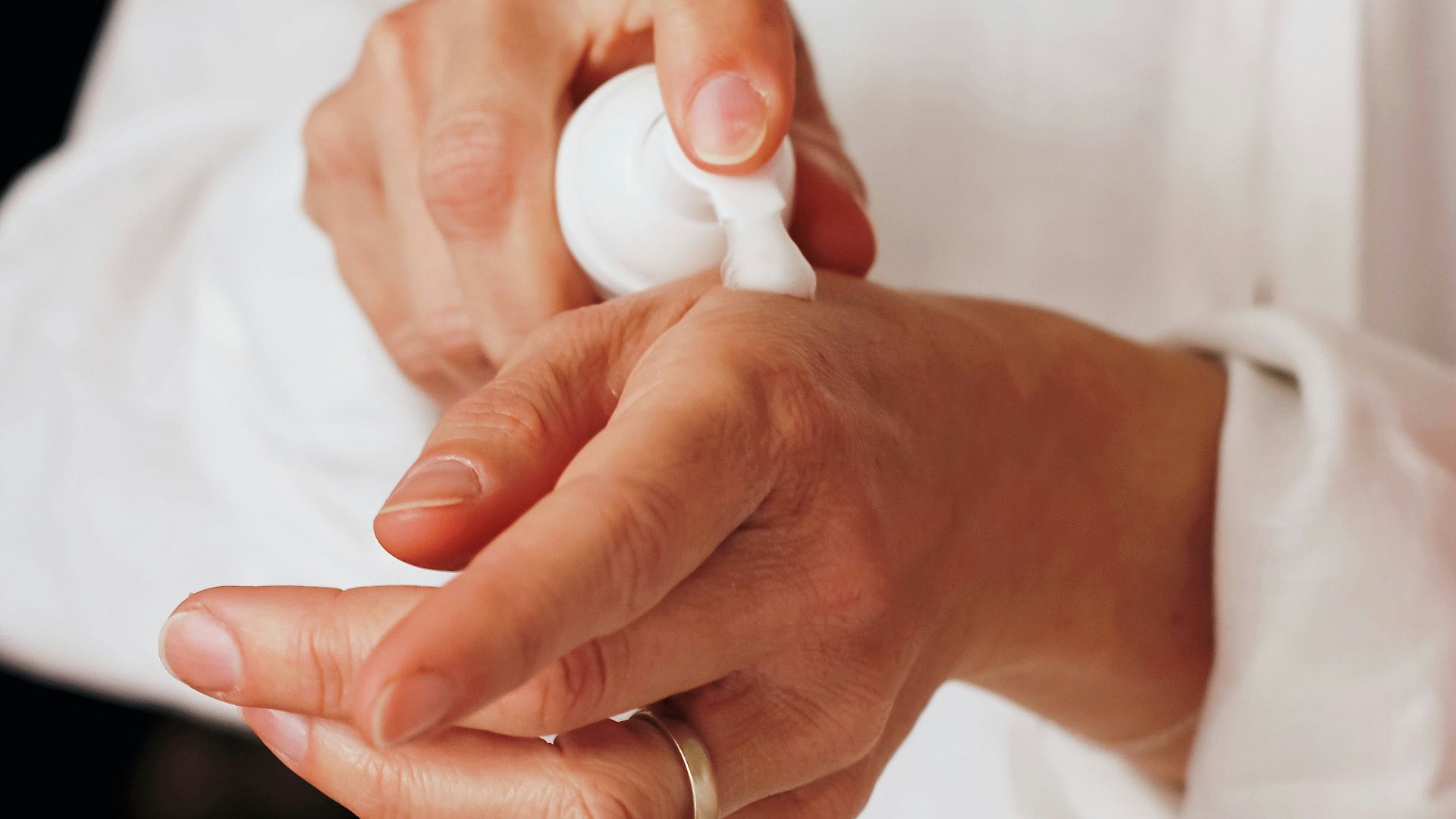 person holding white round ornament