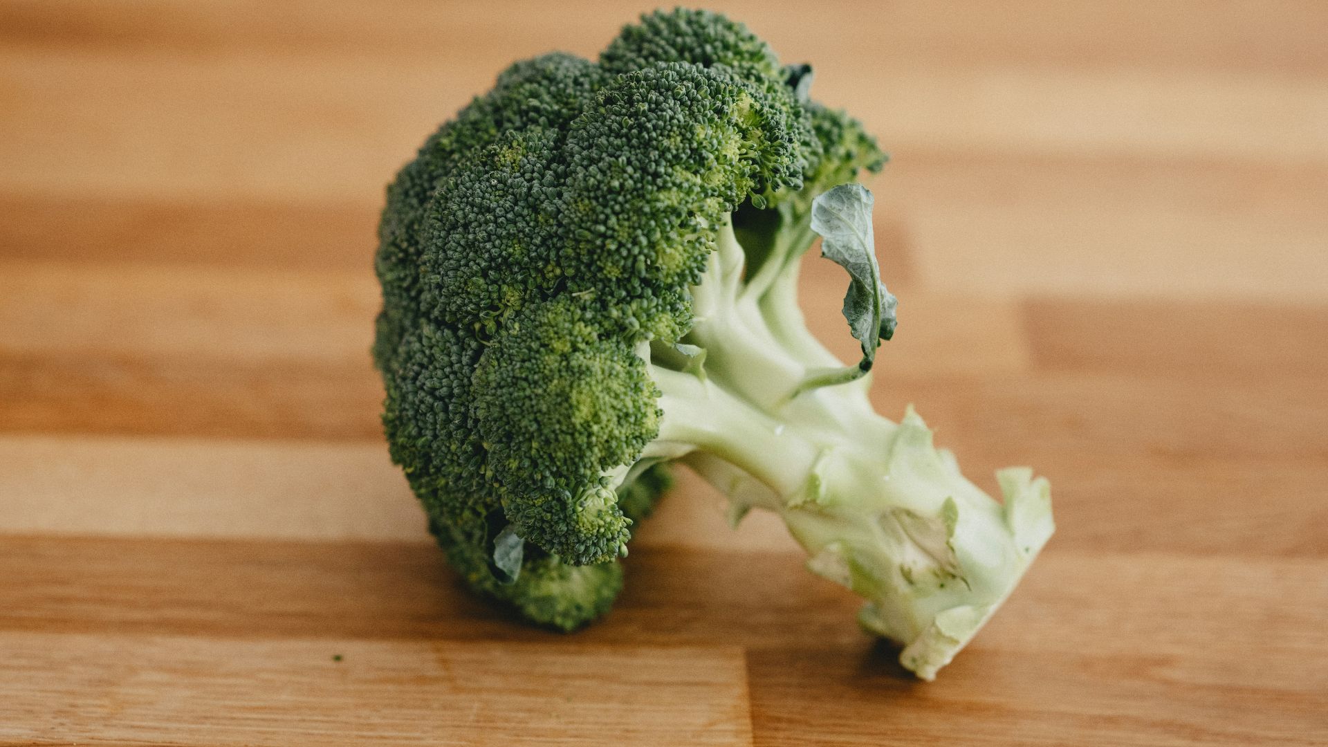 green broccoli on brown wooden table