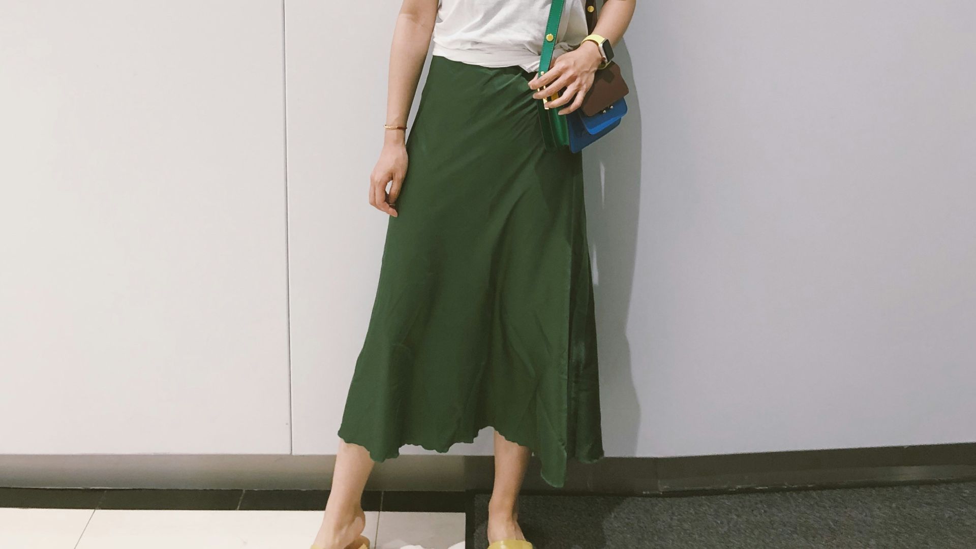 woman looking at her right standing against the wall