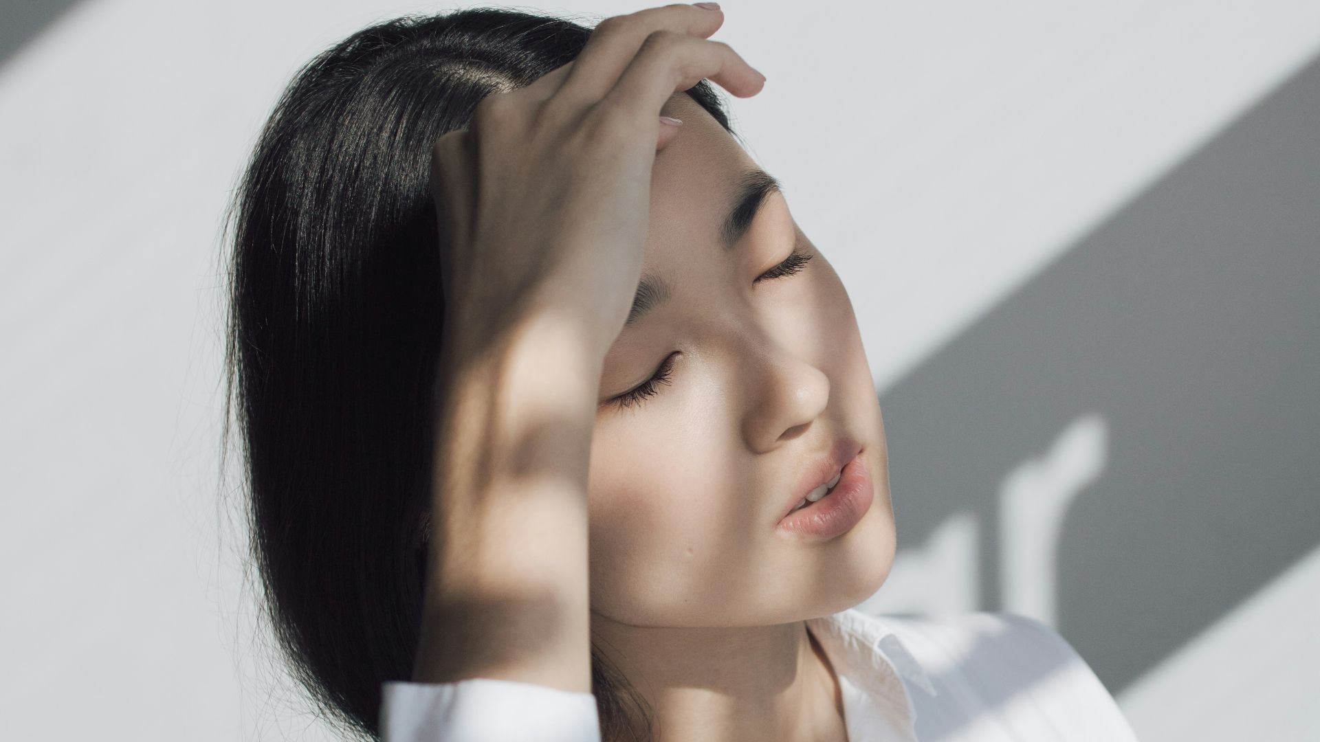 woman leaning on white table