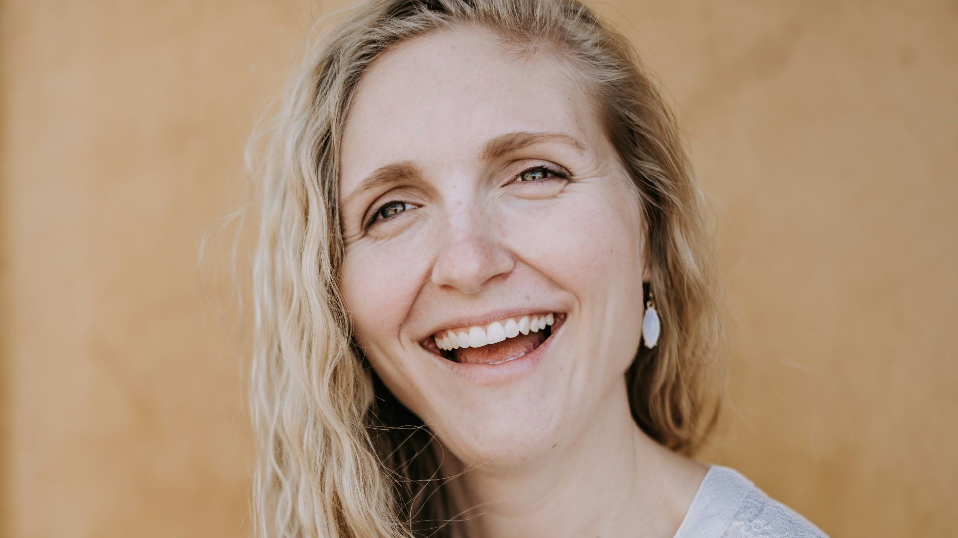 smiling woman in white lace shirt