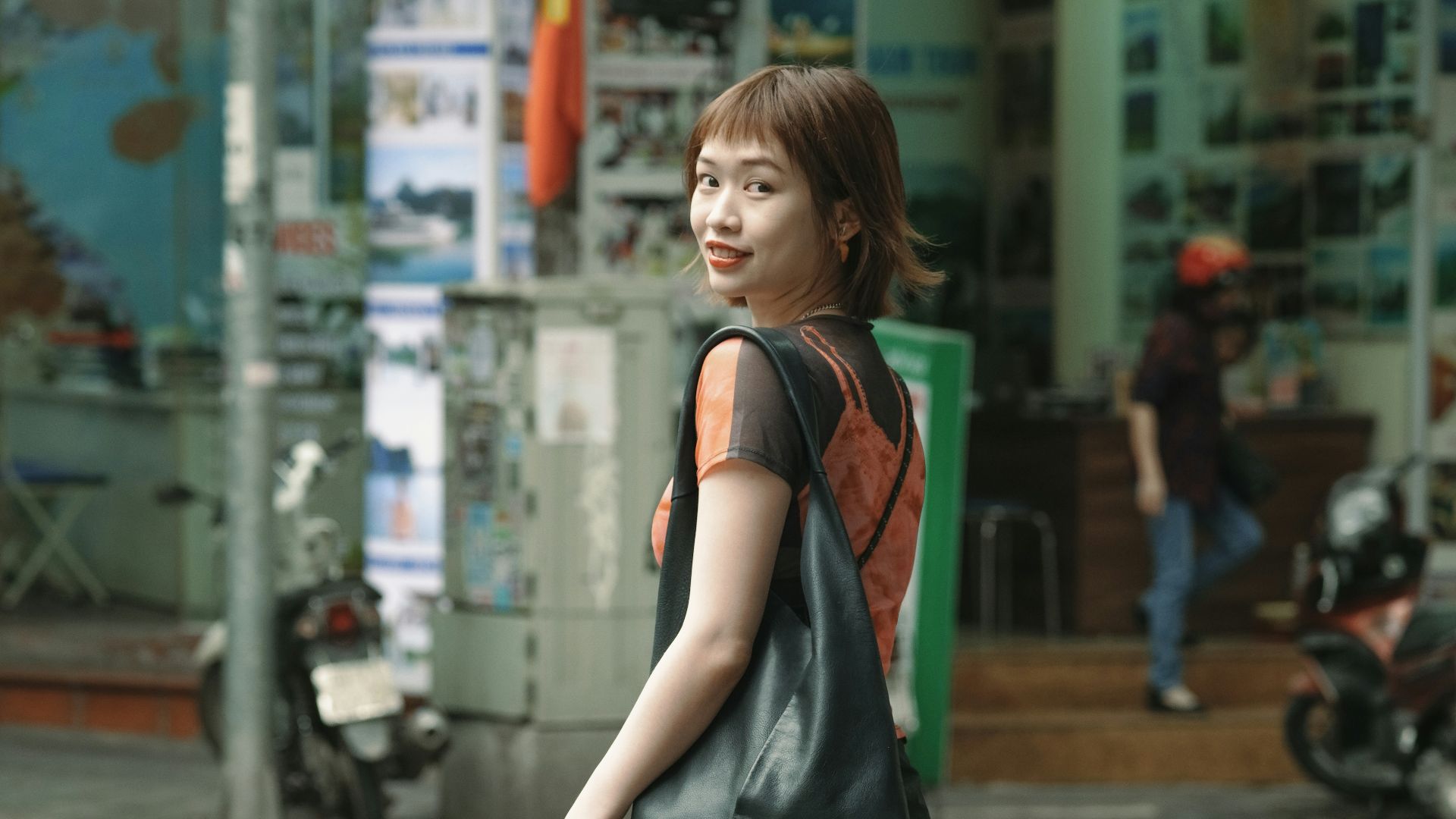 A woman standing on the side of a street