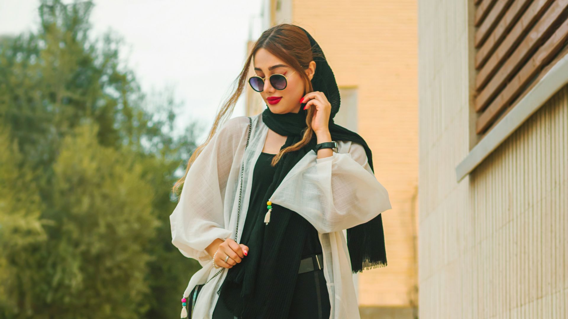 a woman in a black and white outfit is talking on a cell phone