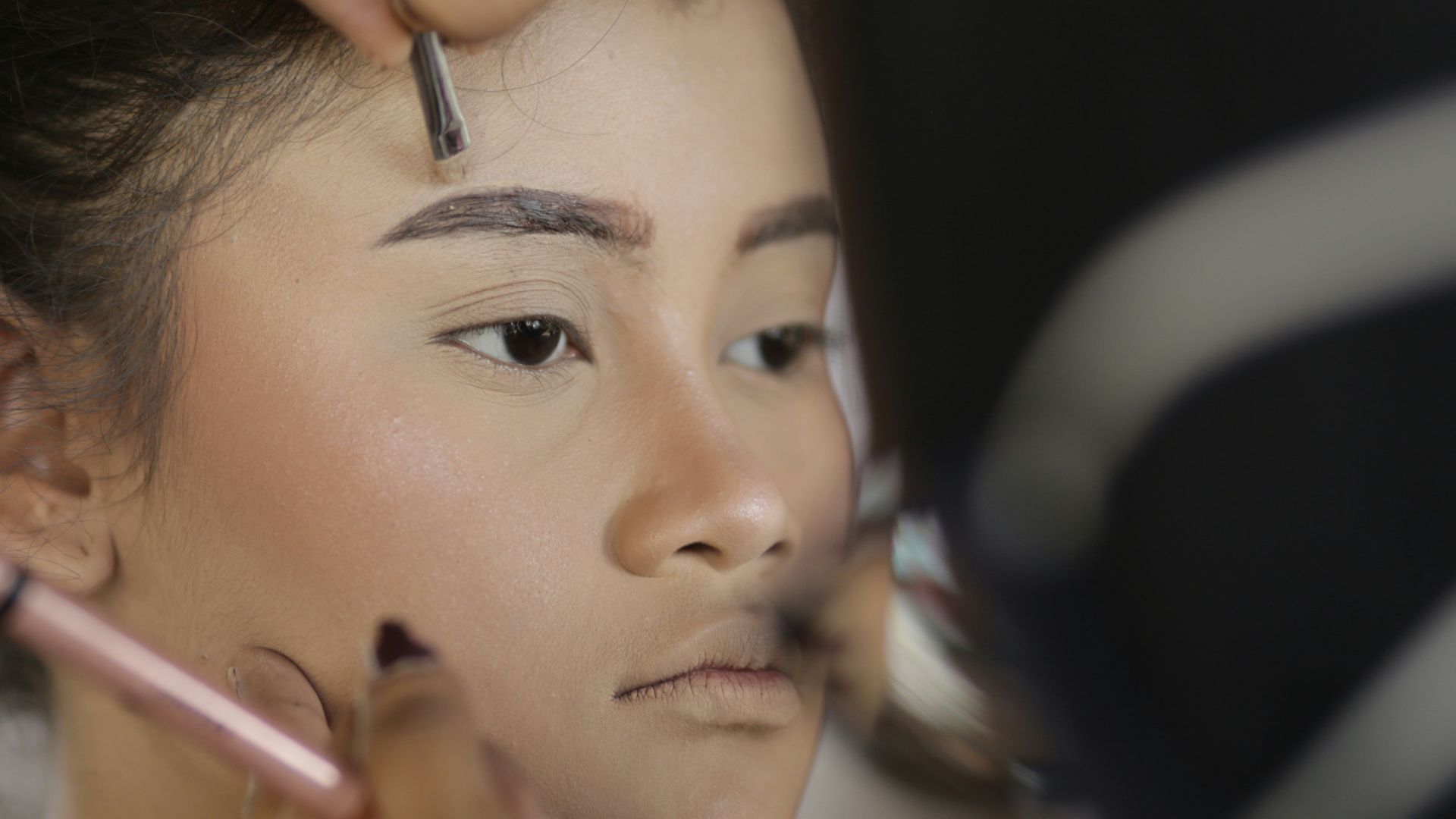 a woman getting her hair done by a professional hair stylist