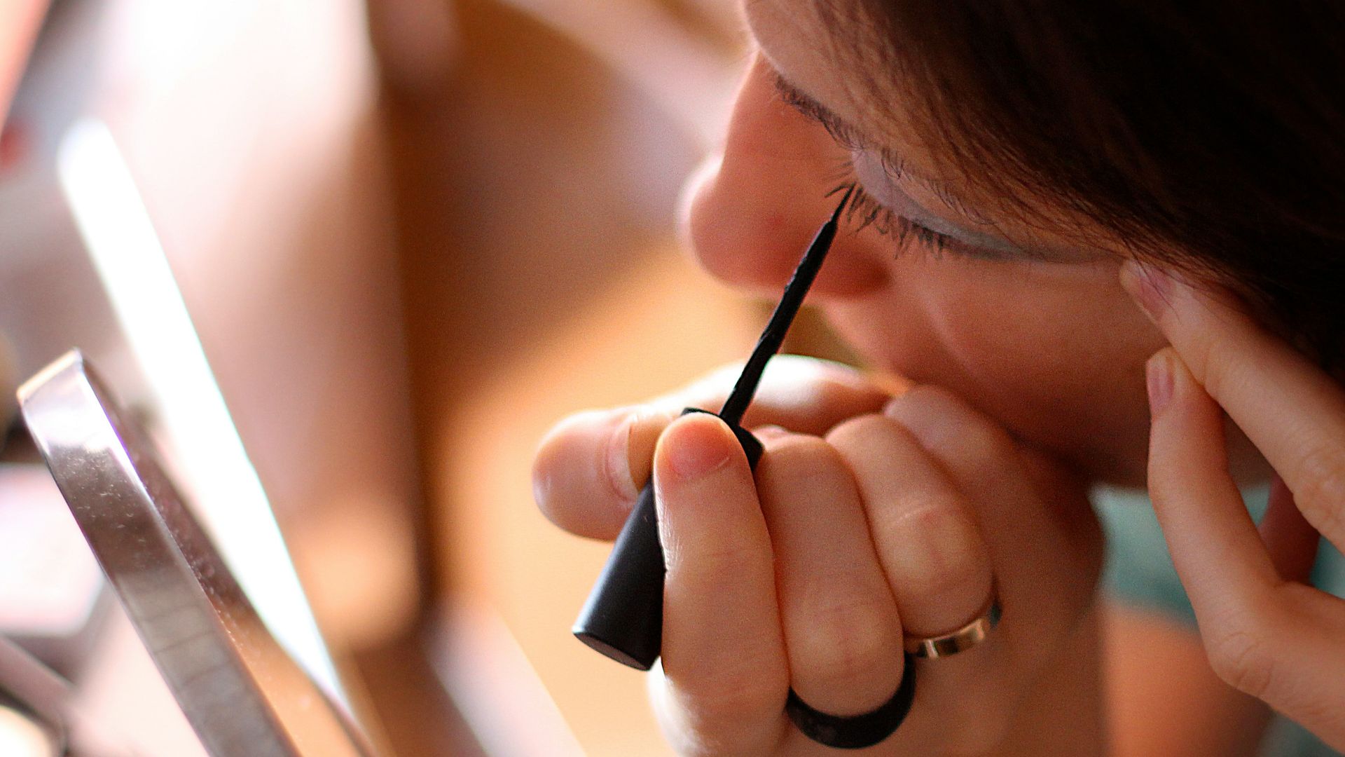 A woman sitting at a desk using a laptop computer