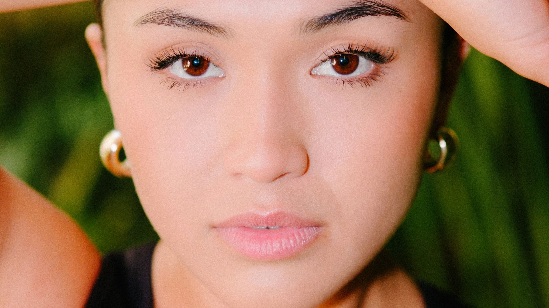 a woman is posing for a picture with her hand on her head