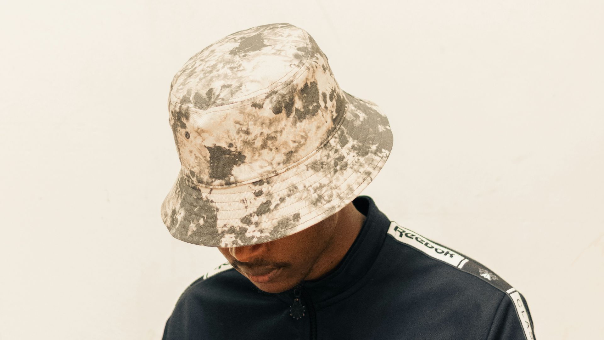 a man wearing a hat sitting on a chair