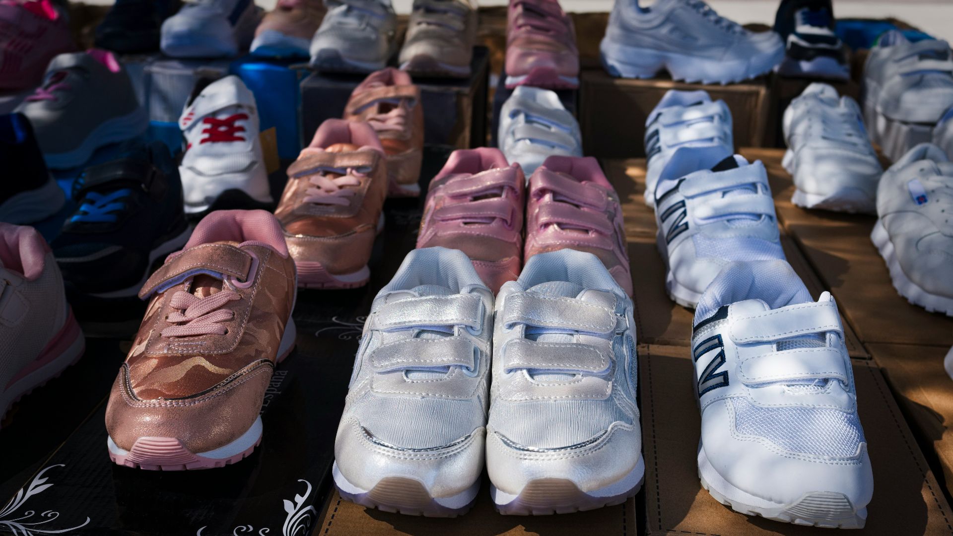 a person lying on a shelf with shoes on it
