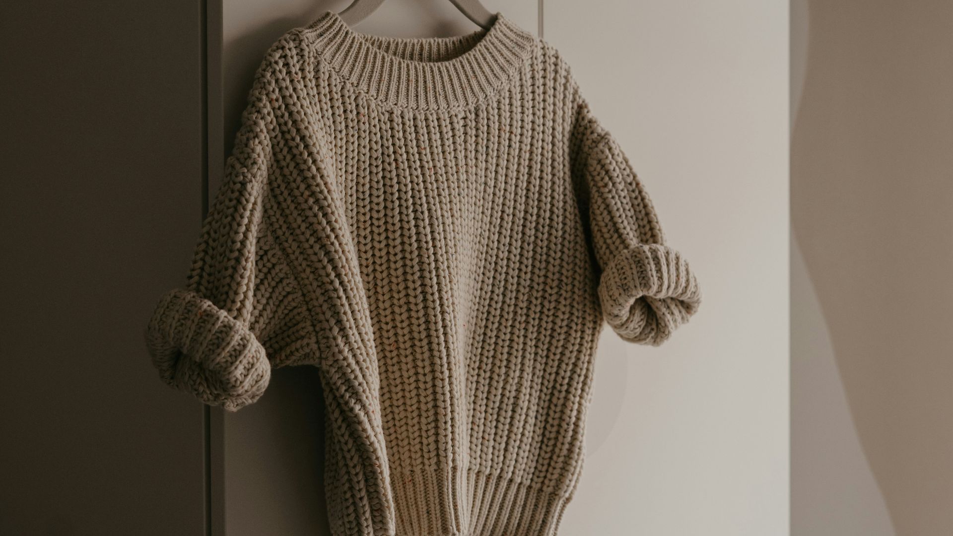 a sweater hanging on a hook in a room