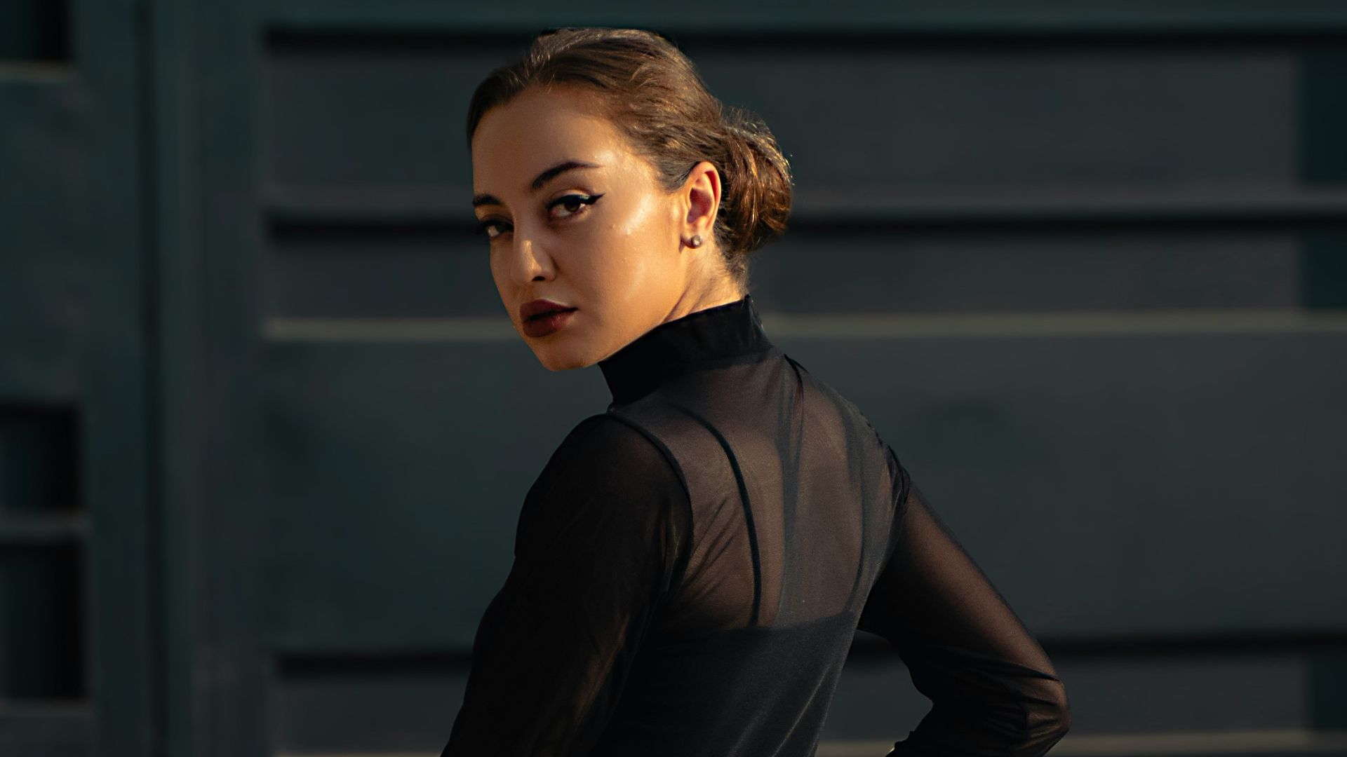 A woman standing in front of a garage door