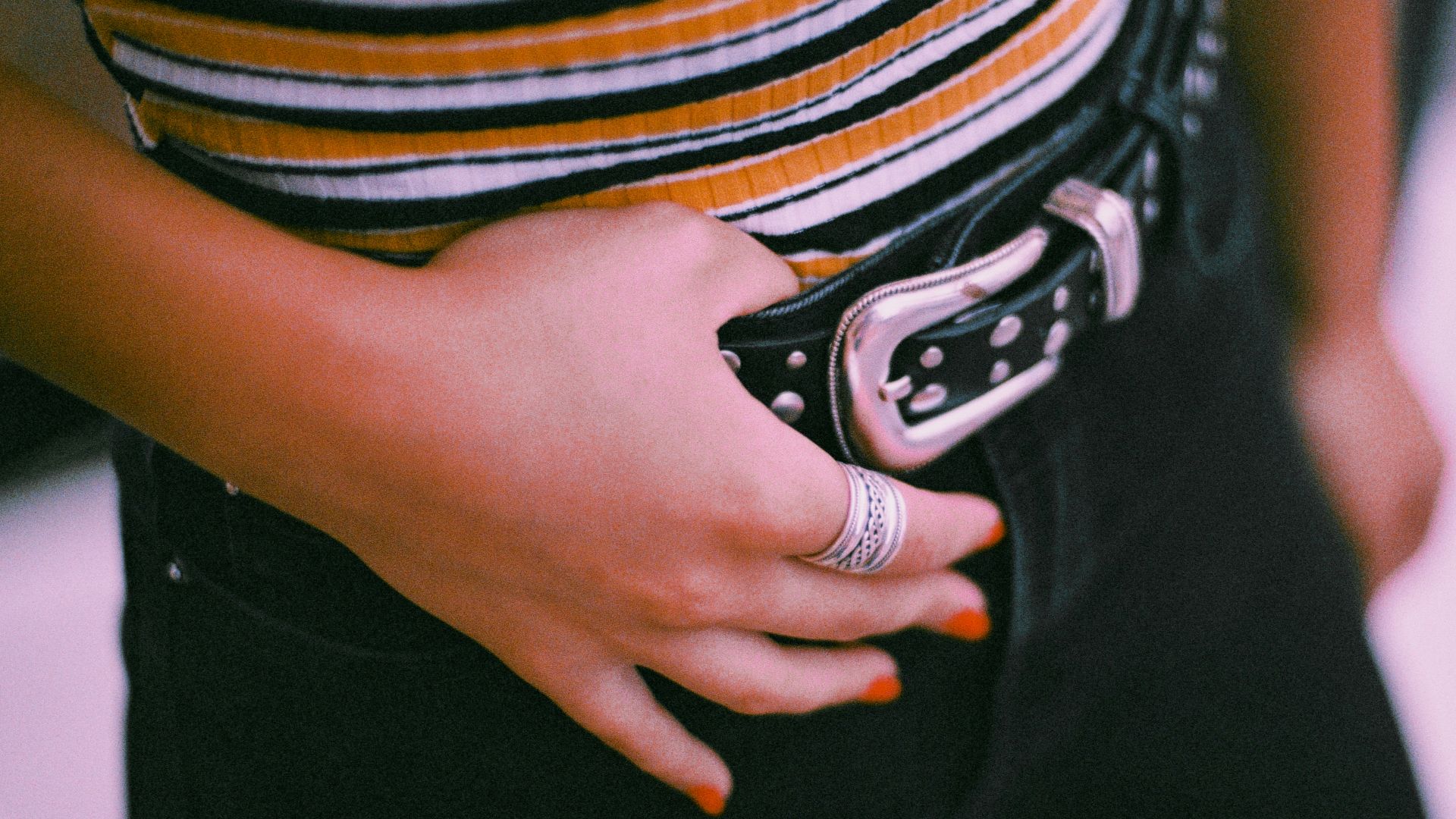 person in black pants and white and black striped shirt