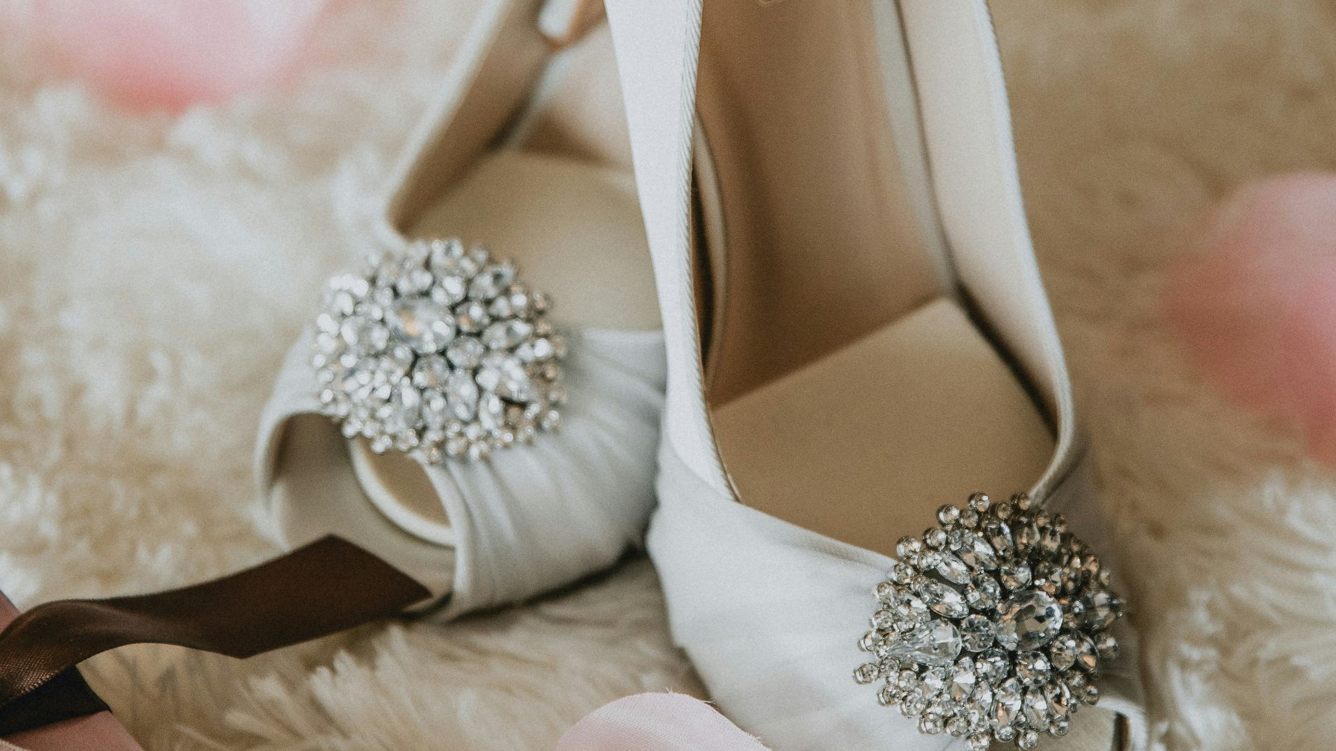 pair of white leather peep-toe heeled shoes with bow accent