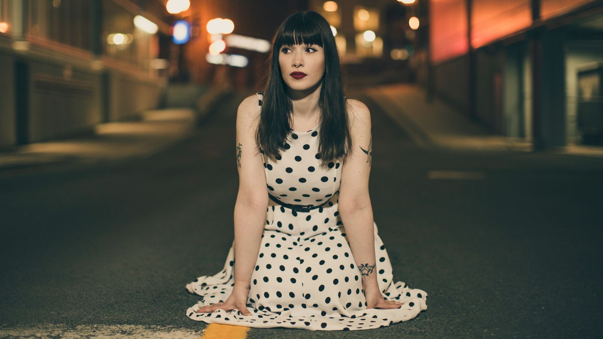 woman wearing white and black polka-dot dress