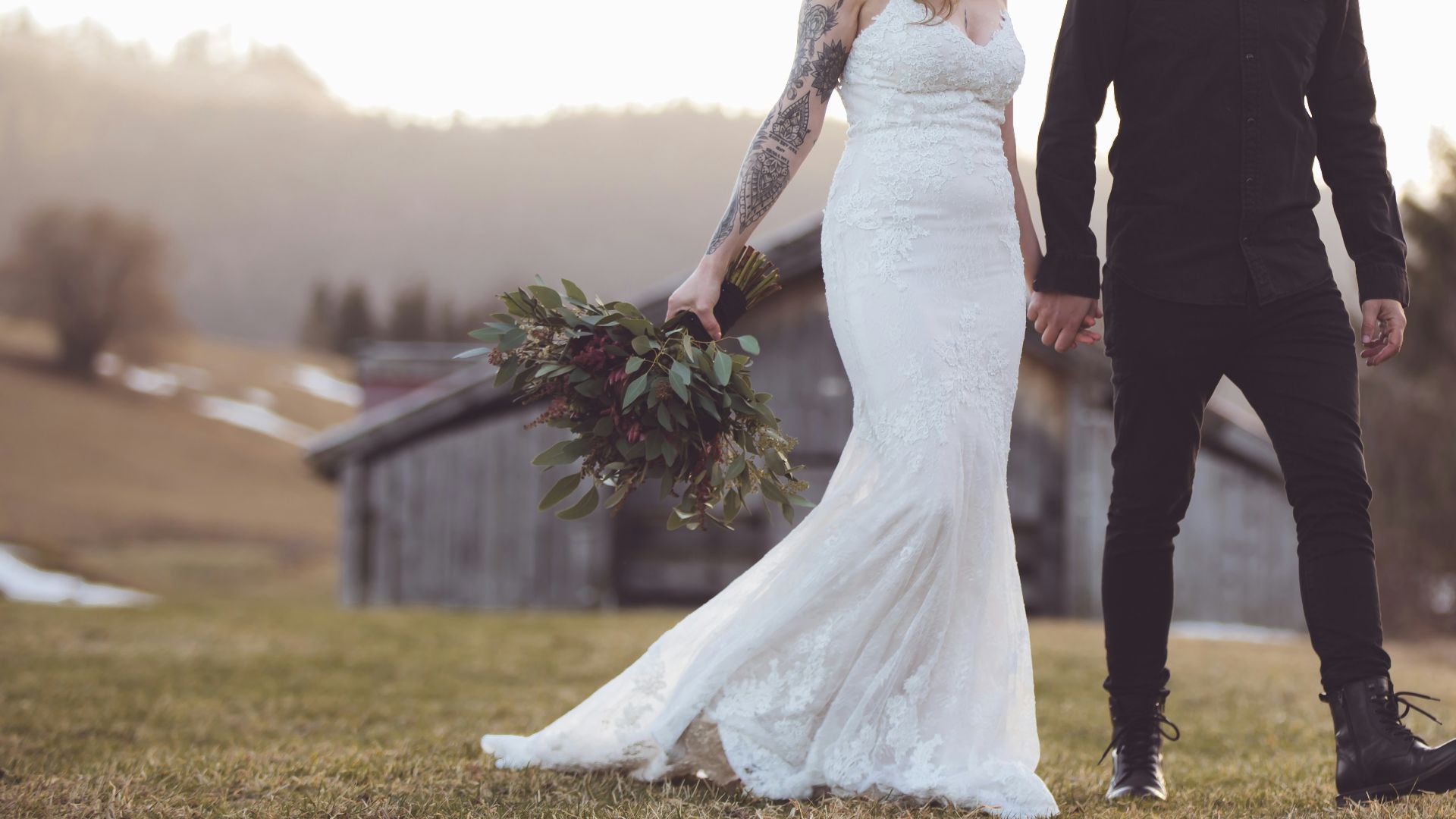 woman in white wedding gown standing beside man in black suit