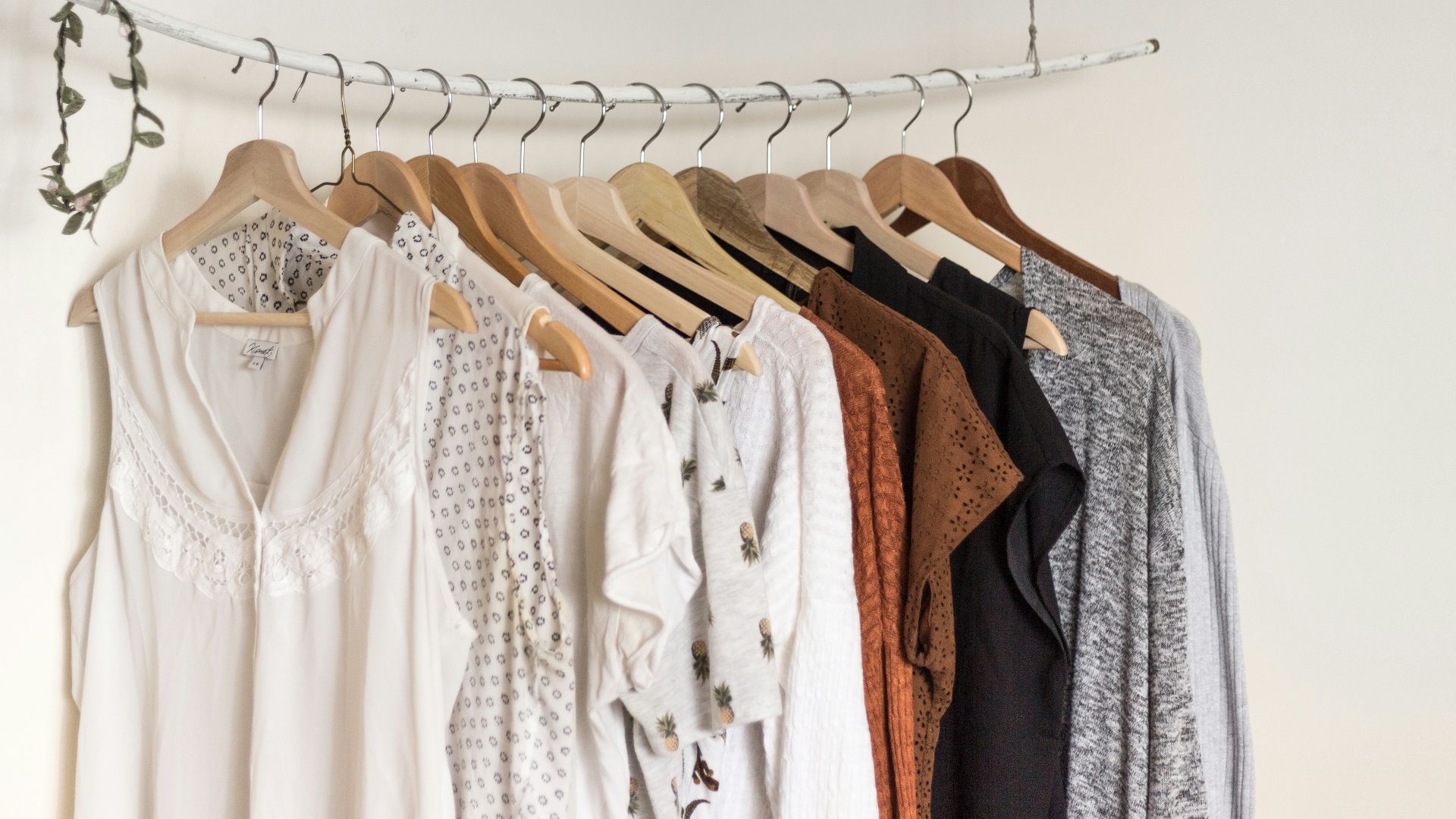 assorted clothes in wooden hangers