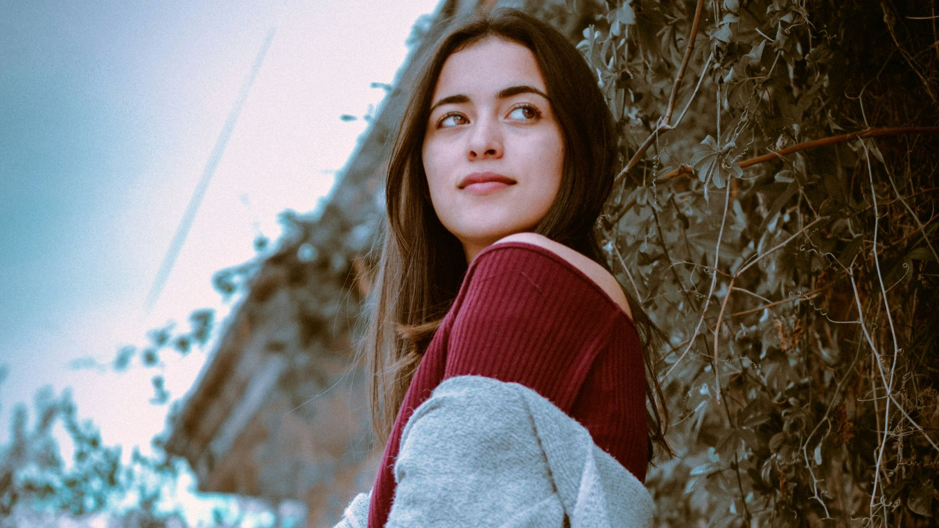 woman standing beside vine plant