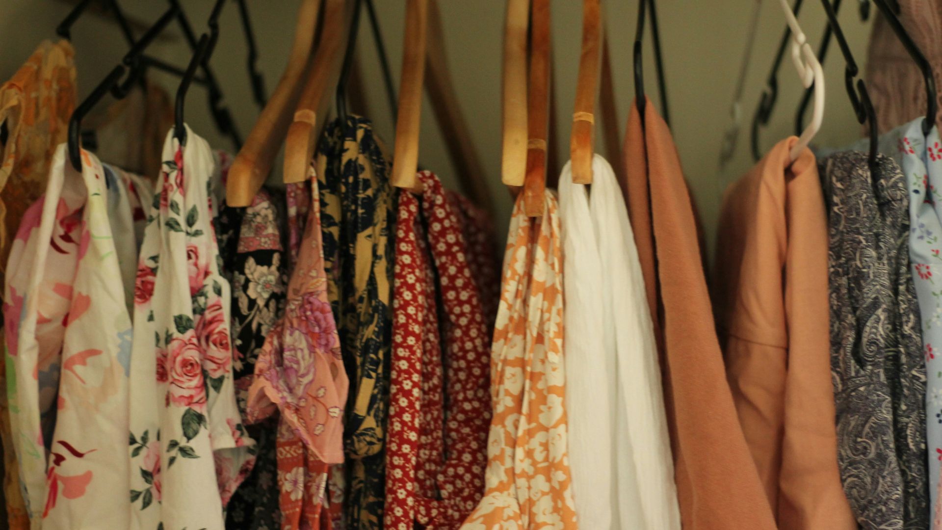 A rack of clothing hanging on a wall