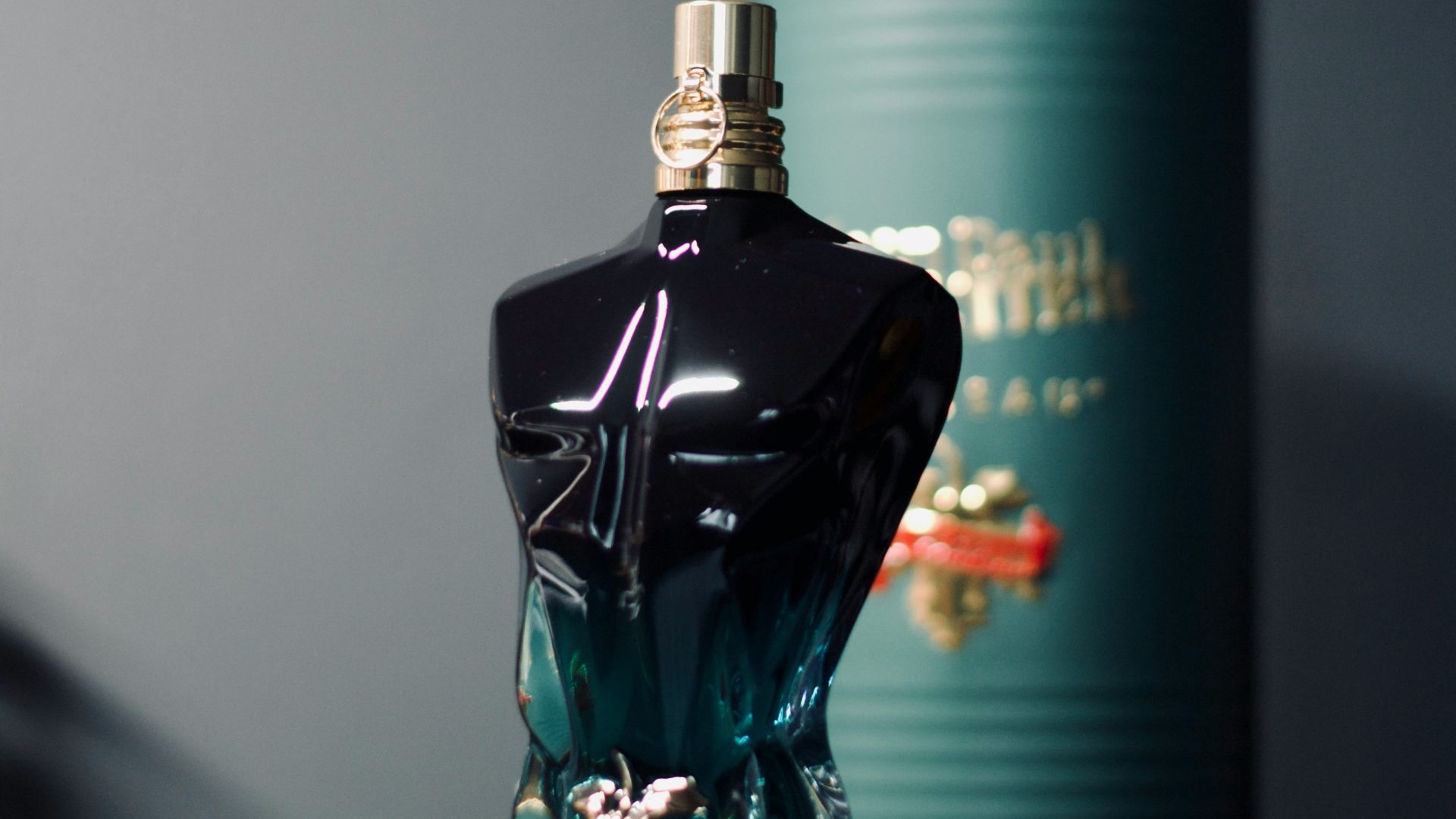 a bottle of perfume sitting next to a can