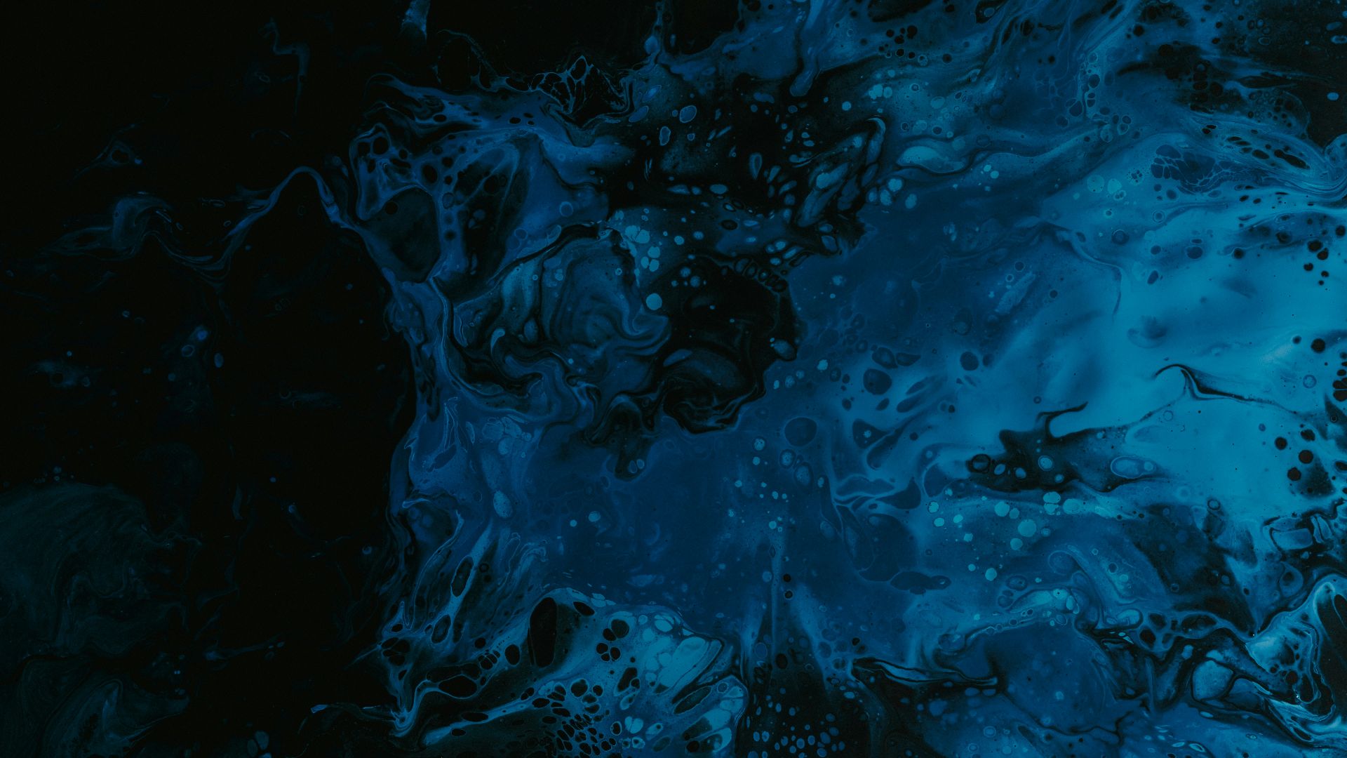 a black and blue background with a lot of bubbles