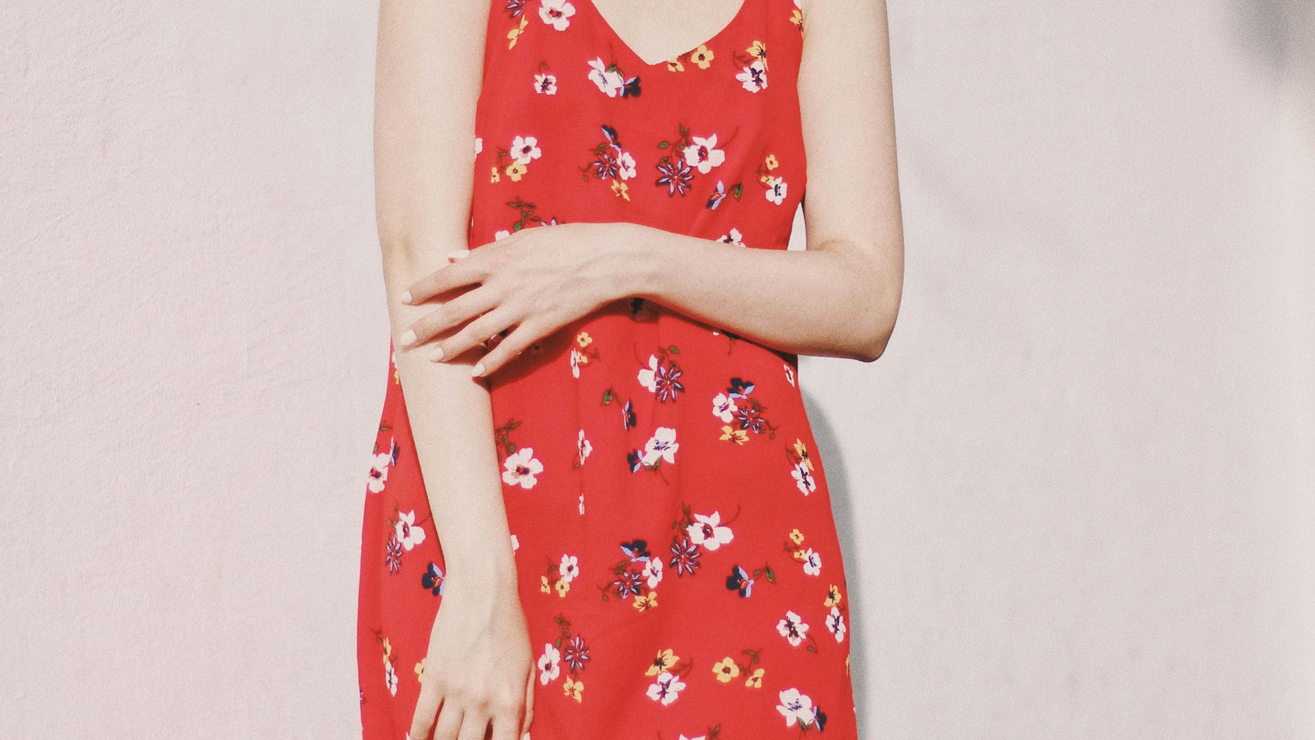 woman standing in front of white wall