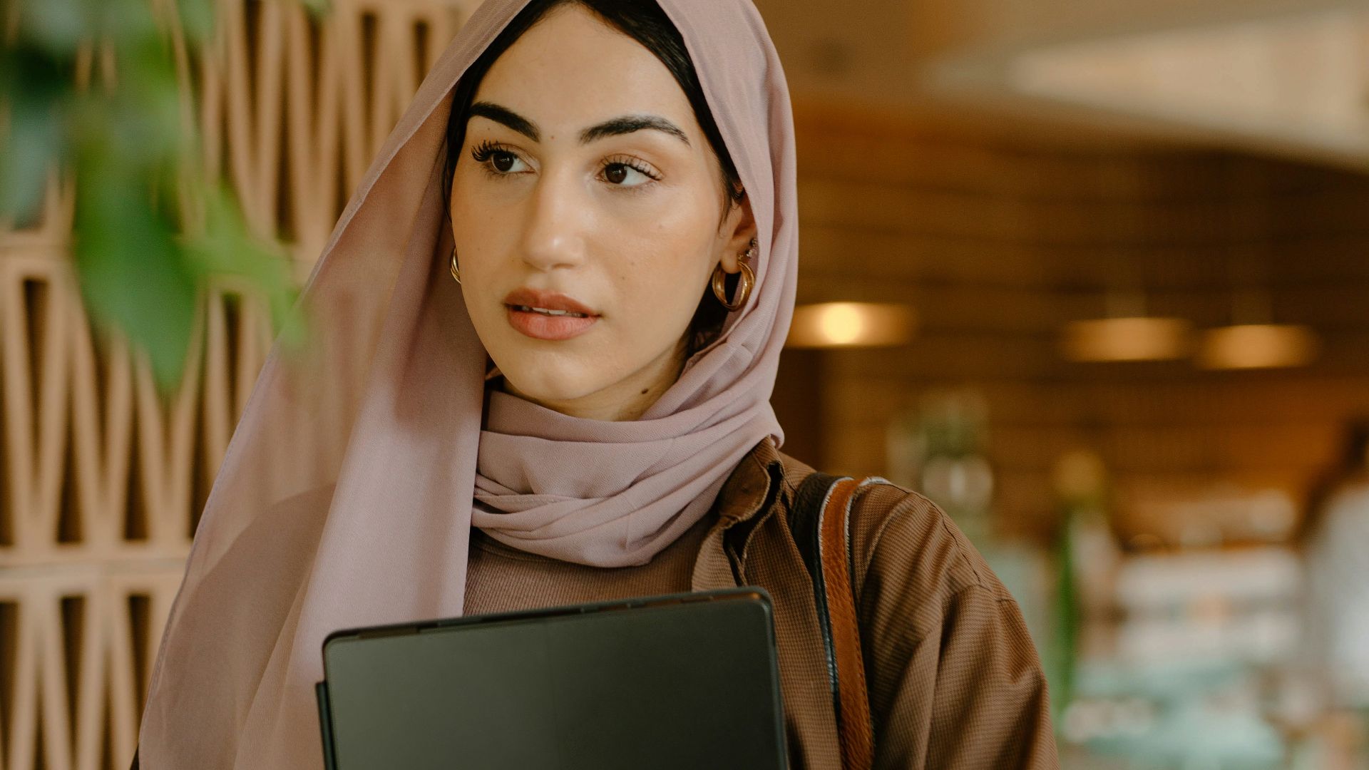 a person holding a laptop