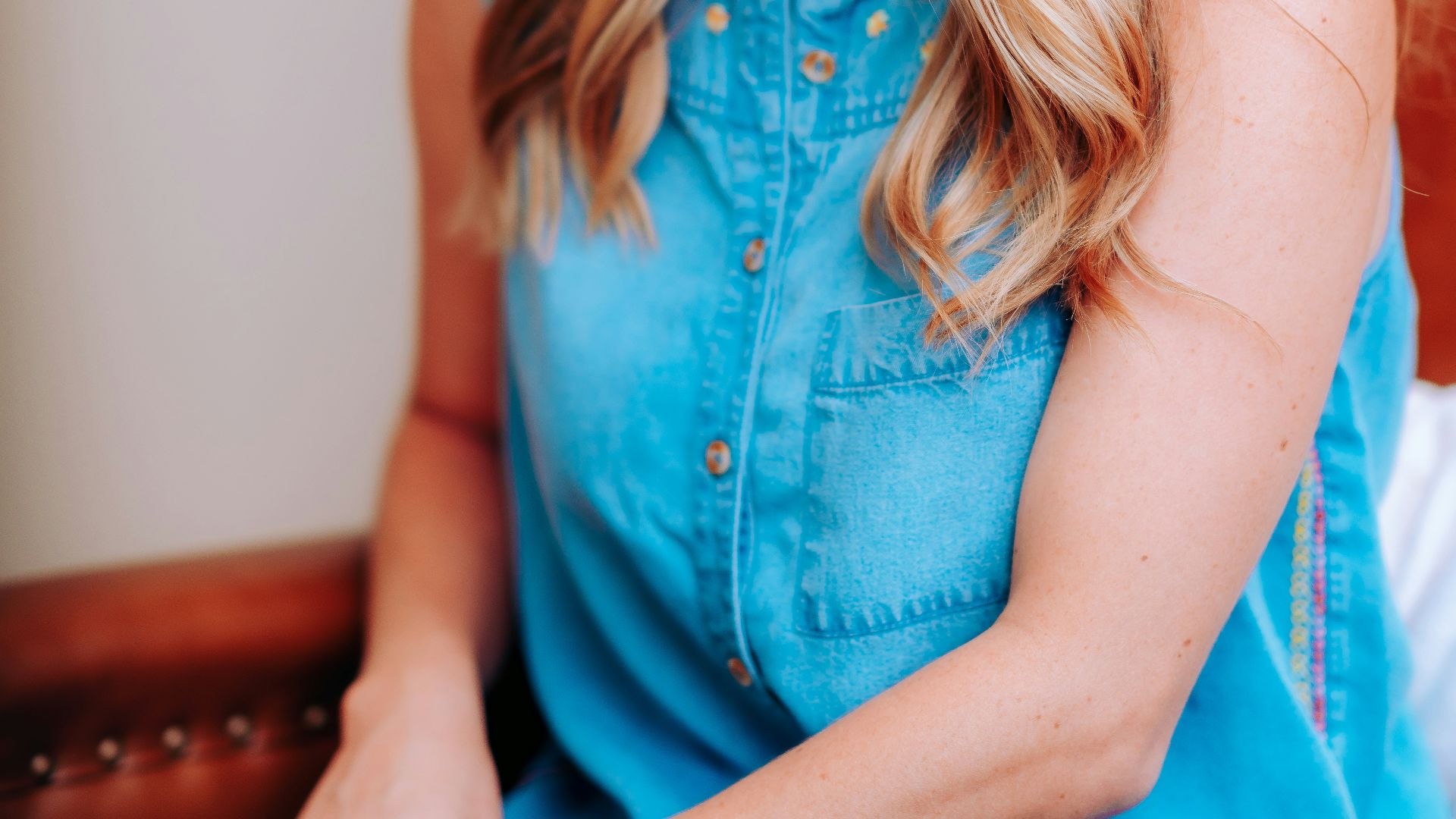smiling girl in blue sleeveless dress