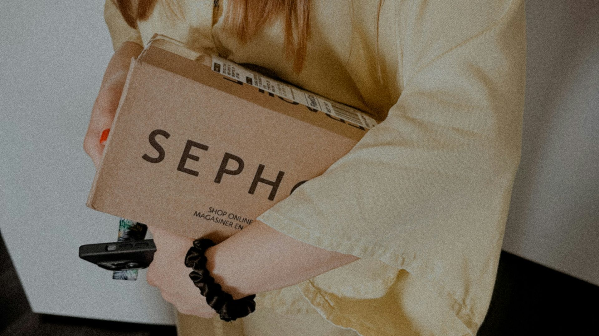 a woman holding a cardboard box with the word sep on it