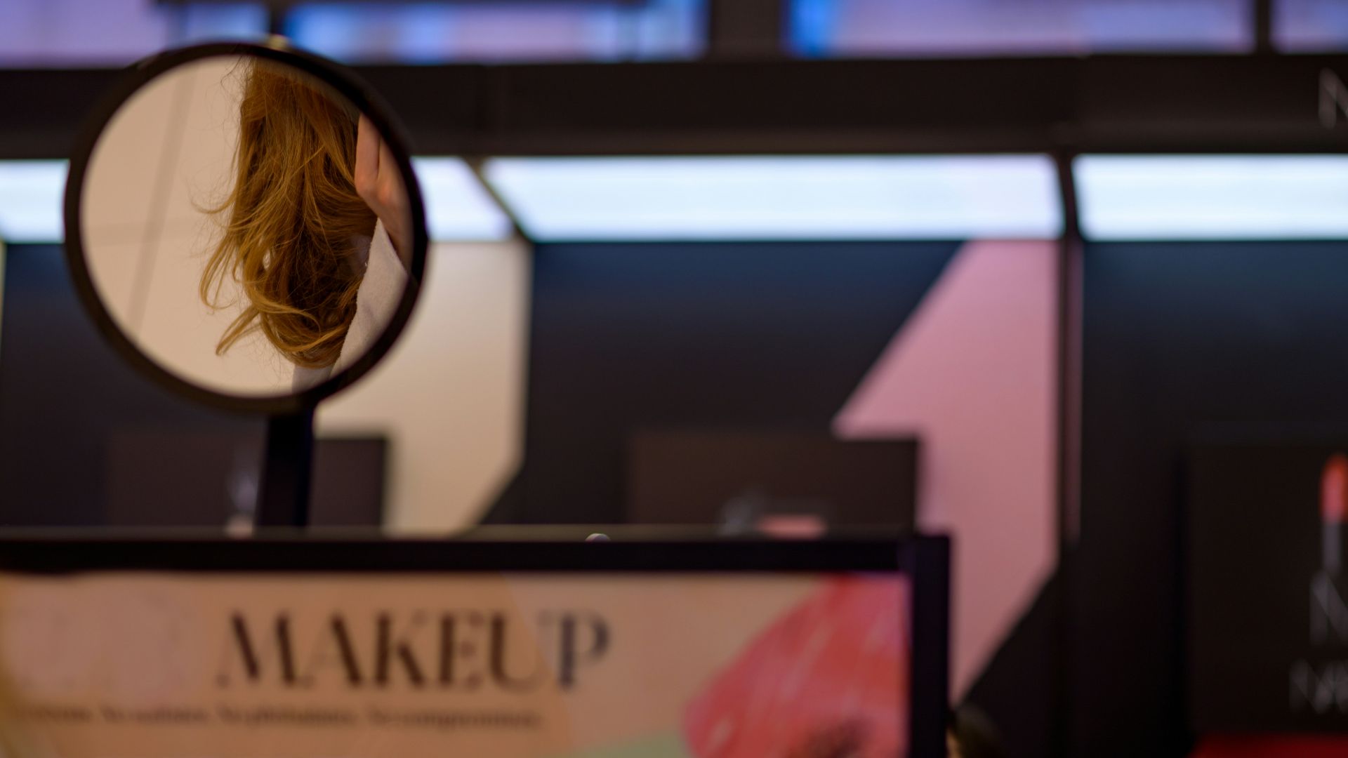 a woman's reflection in a round mirror