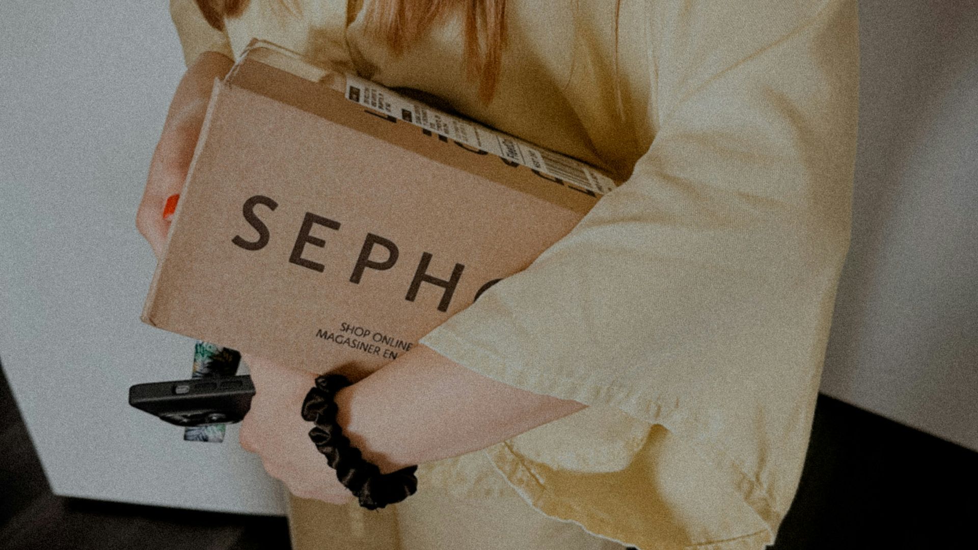 a woman holding a cardboard box with the word sep on it