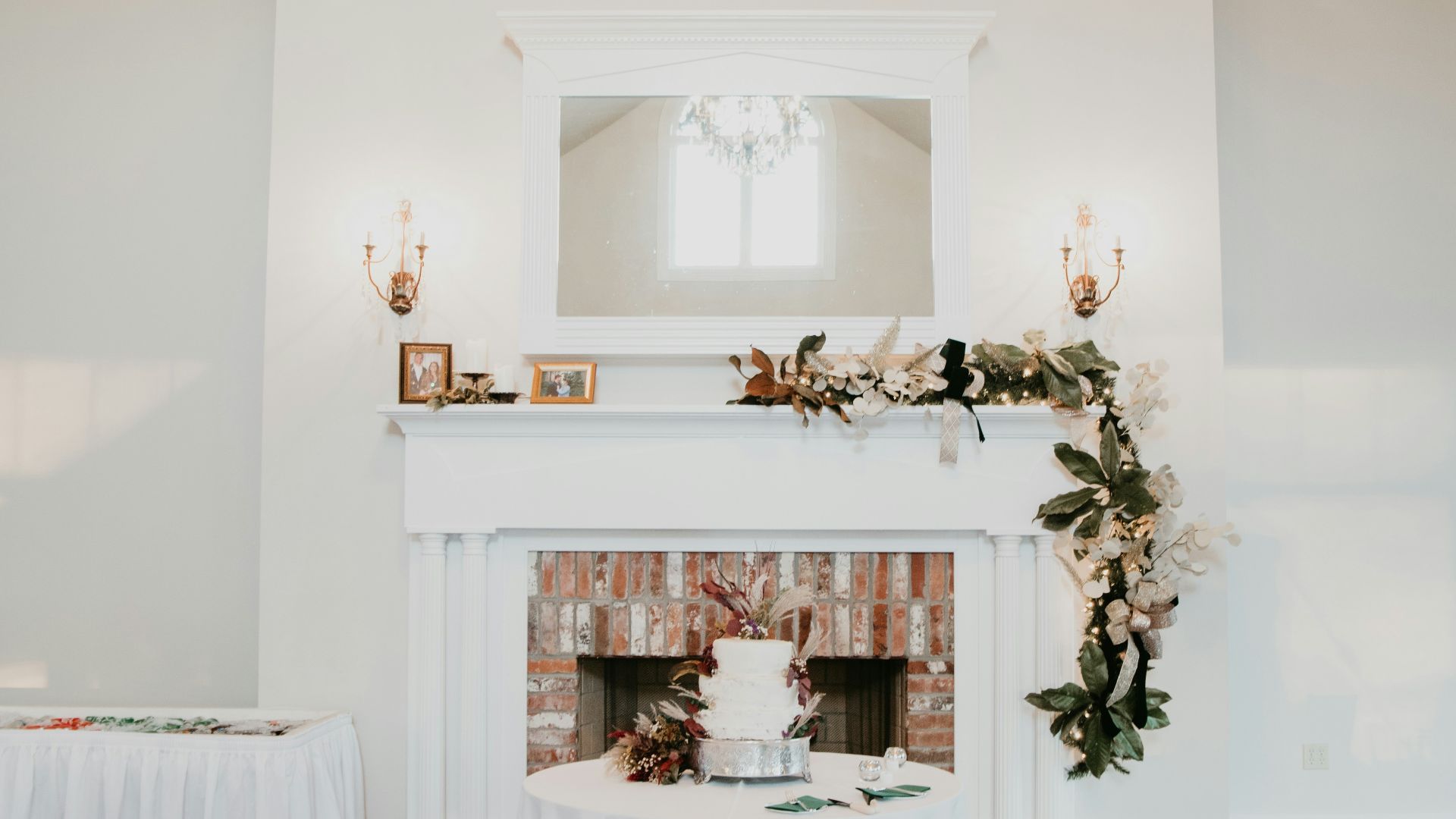 a table with a cake on it in front of a fireplace