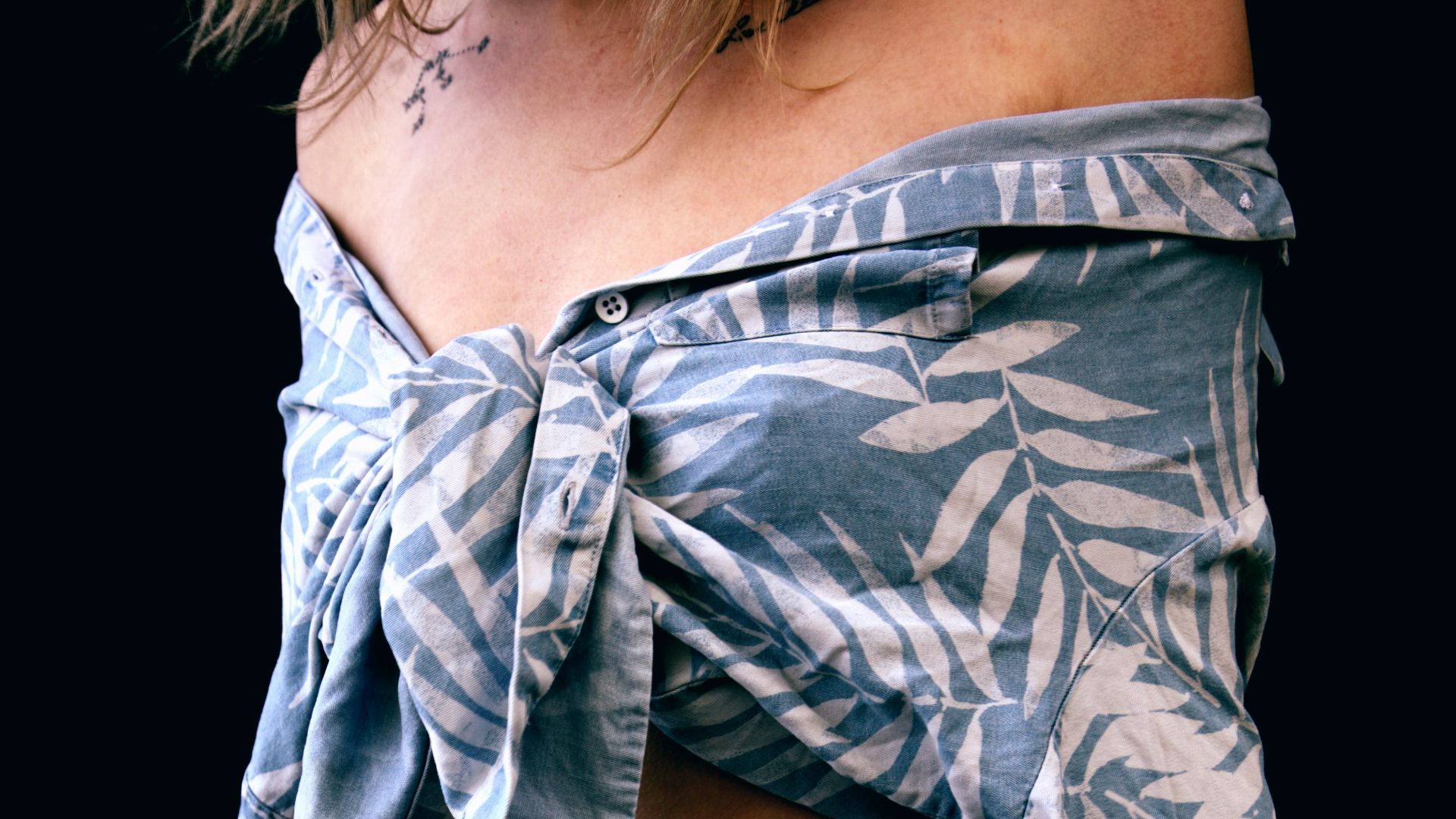 woman in gray and black floral long sleeve shirt and blue denim jeans