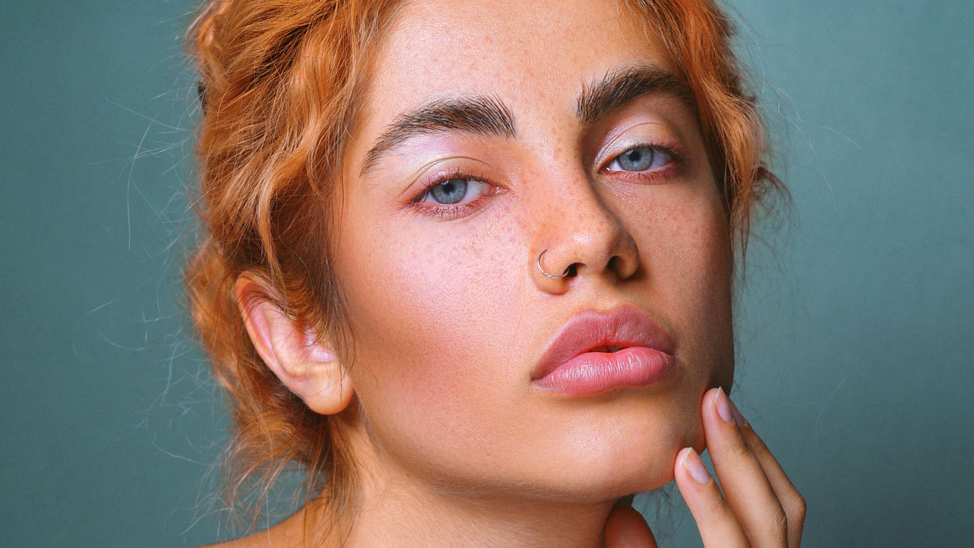 a woman with freckled hair is posing for a picture