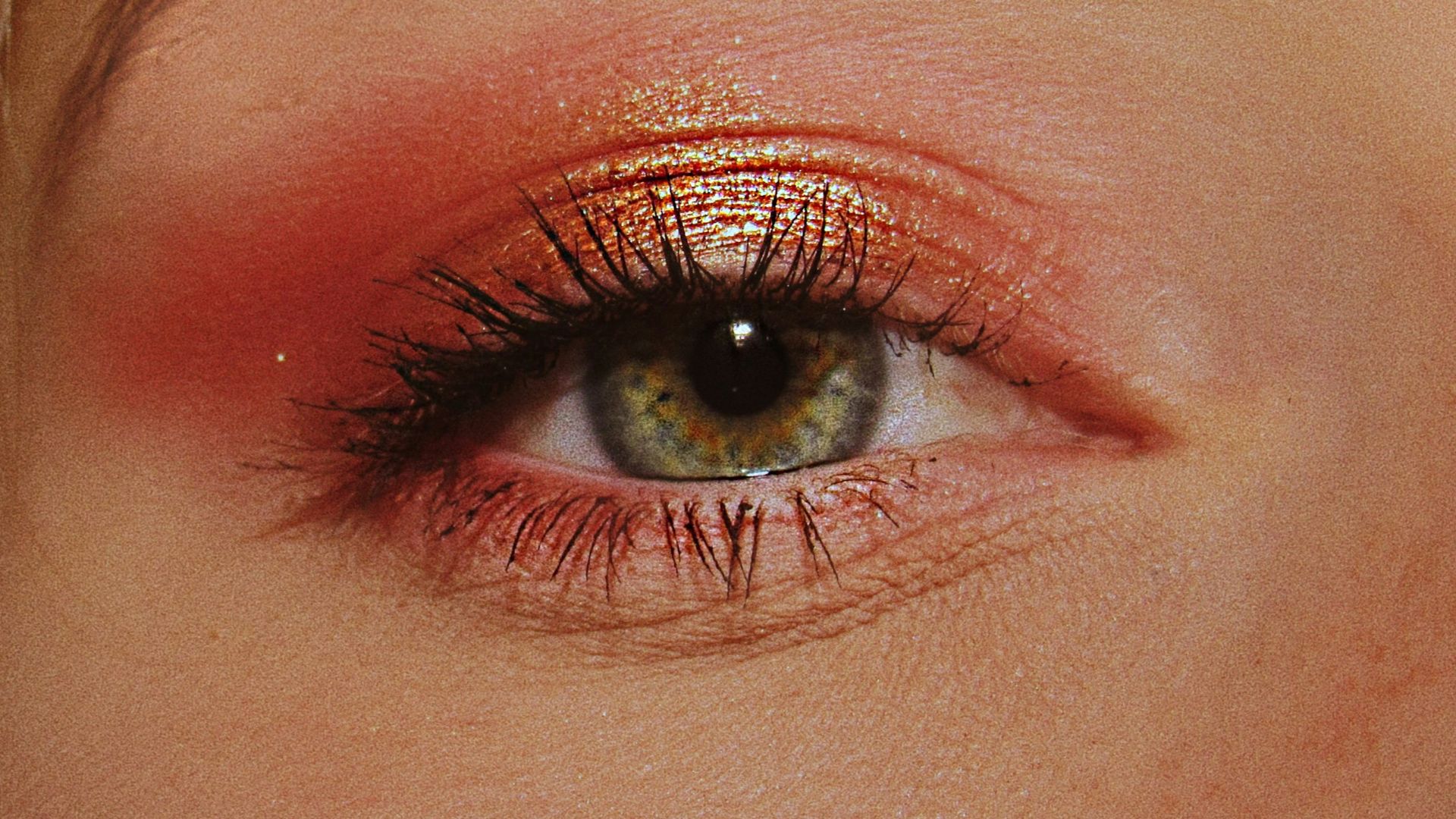 woman with pink and gold eyeshadow makeup